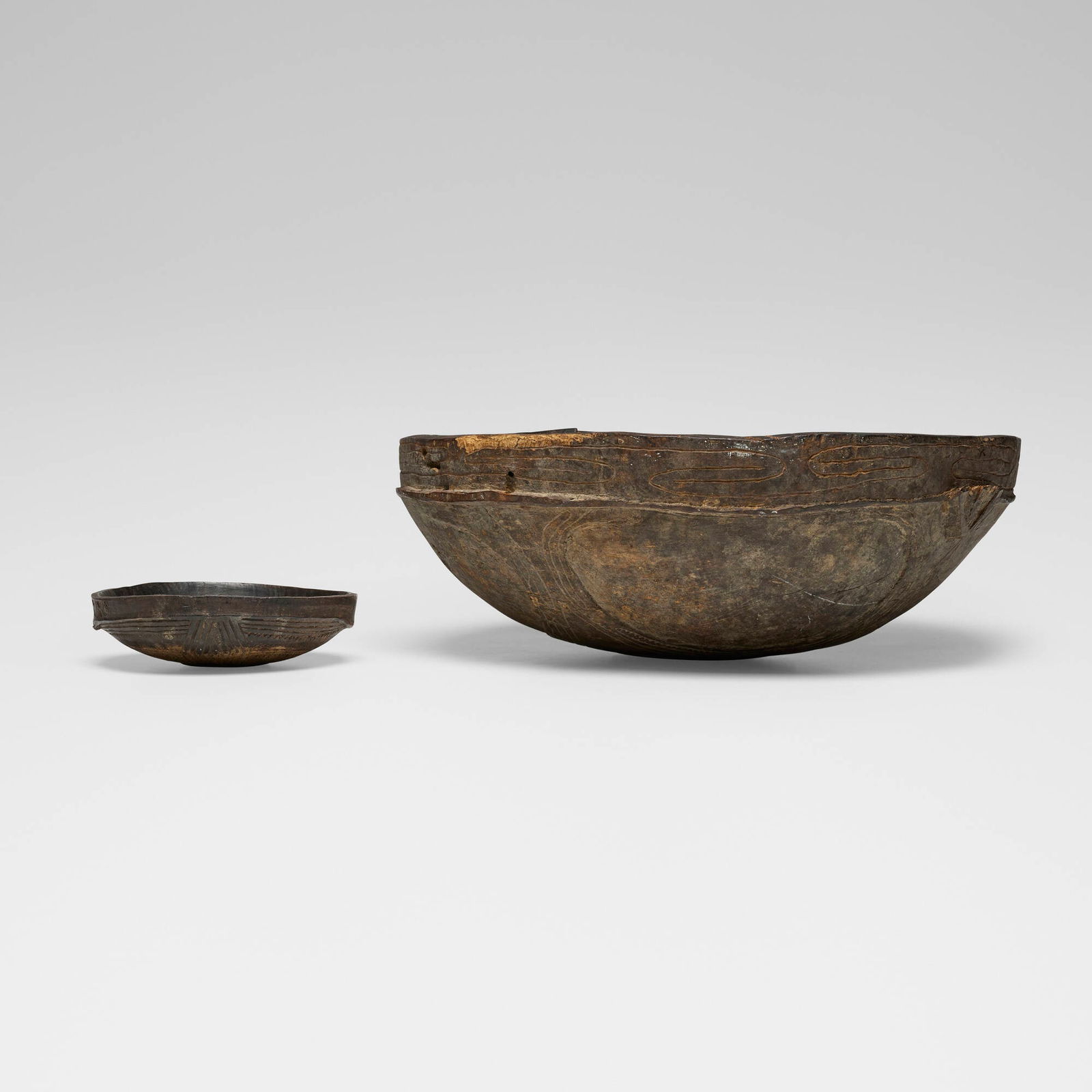 Papuan, Boiken plates, set of two: Papuan Boiken plates, set of two New Guinea carved wood 2 h x 7.75 dia in (5 x 20 cm) 7 h x 19.5 dia in (18 x 50 cm) This work will ship from Chicago, Illinois.