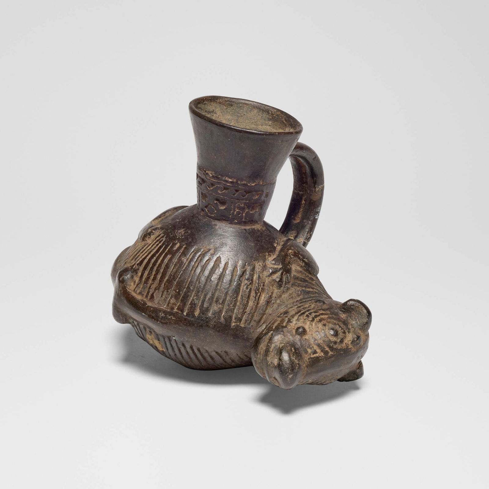 Chimu, Blackware jaguar spouted vessel: Chimu Blackware jaguar spouted vessel Peru, c. 1000-1400 CE earthenware 6 h x 7 w x 5.75 d in (15 x 18 x 15 cm) This work will ship from Los Angeles, California.