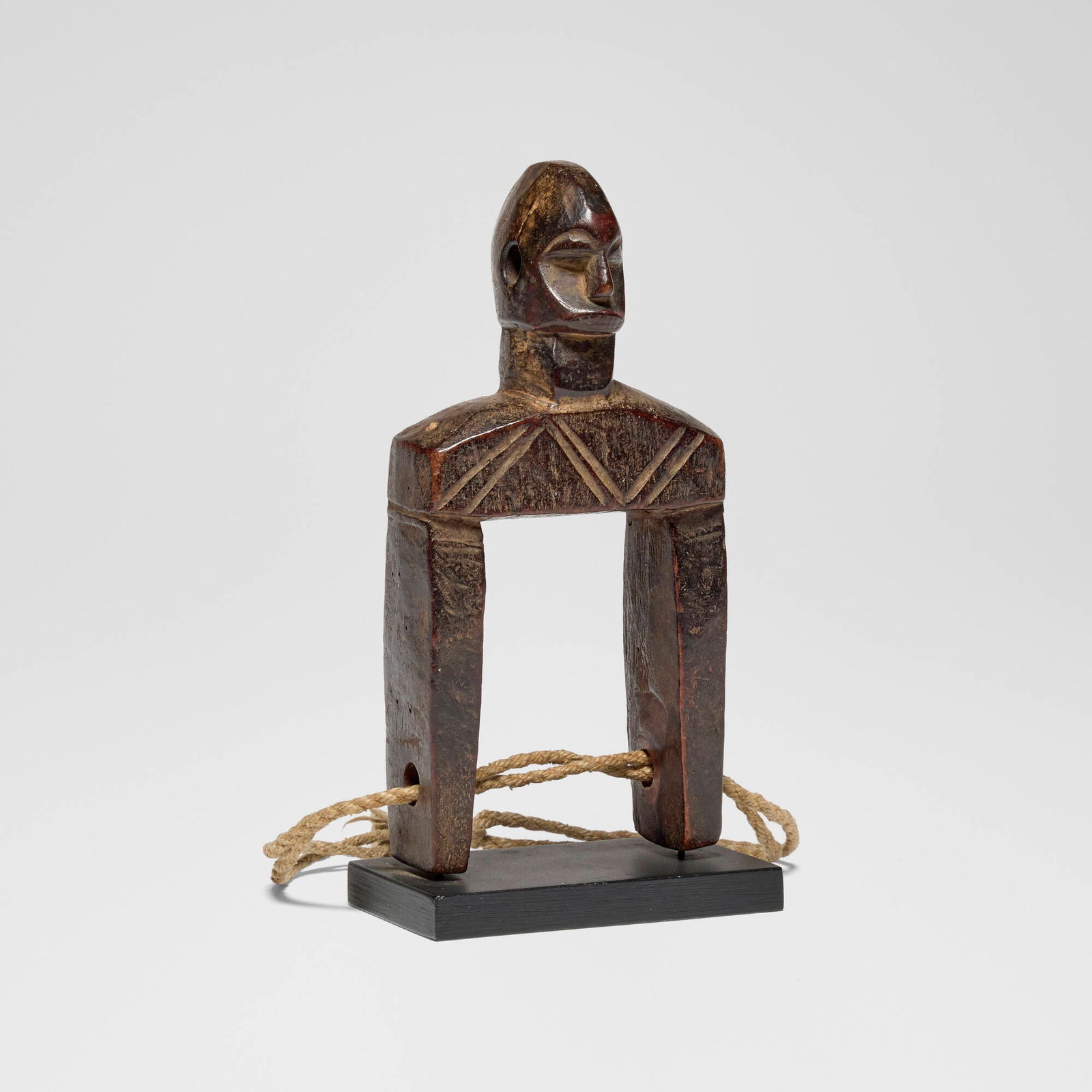 Luba, Heddle pulley: Luba Heddle pulley Democratic Republic of Congo, early 20th century carved wood, rope 7.5 h x 3.75 w x 2.25 d in (19 x 10 x 6 cm) Provenance: Jean-Pierre Hallet, Malibu | Private Collection, Los