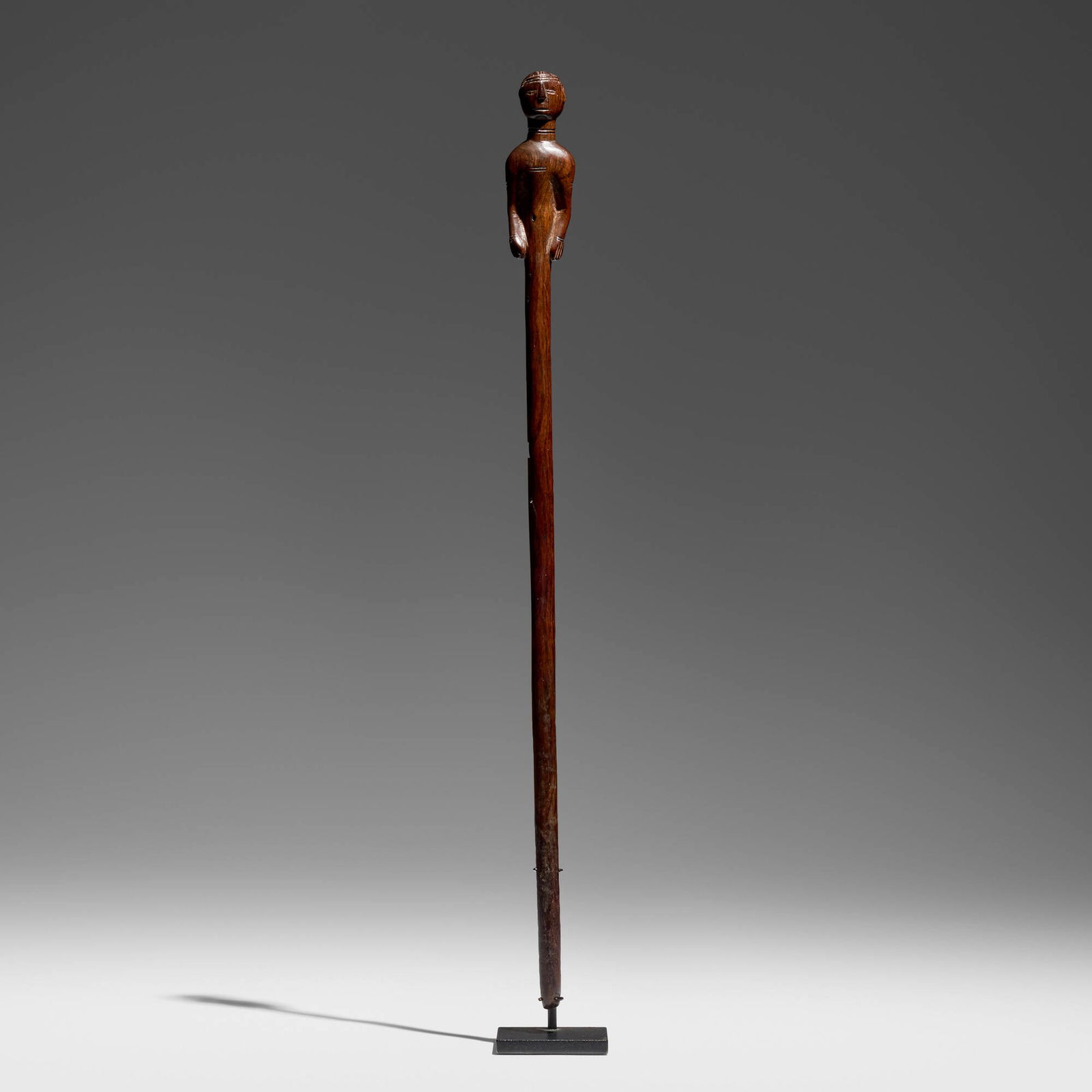 Coastal Tanzania, possibly Zaramo, Figural staff: Coastal Tanzania, possibly Zaramo Figural staff mid 20th century carved-mahogany 25.25 h x 2 w x 1.25 d in (64 x 5 x 3 cm) Provenance: Jean-Pierre Hallet, Malibu | Private Collection, Los Angeles 