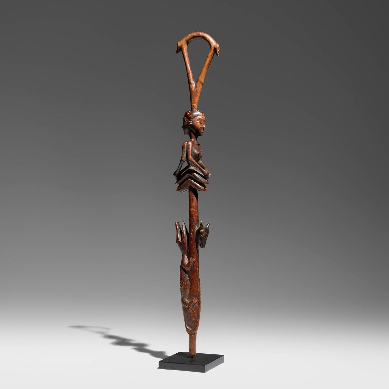 Pende, Janus staff with animals: Pende Janus staff with animals Democratic Republic of the Congo, early 20th century carved wood 30.25 h x 4.5 w x 4.5 d in (77 x 11 x 11 cm) Staff features a seated Janus female figure beneath a