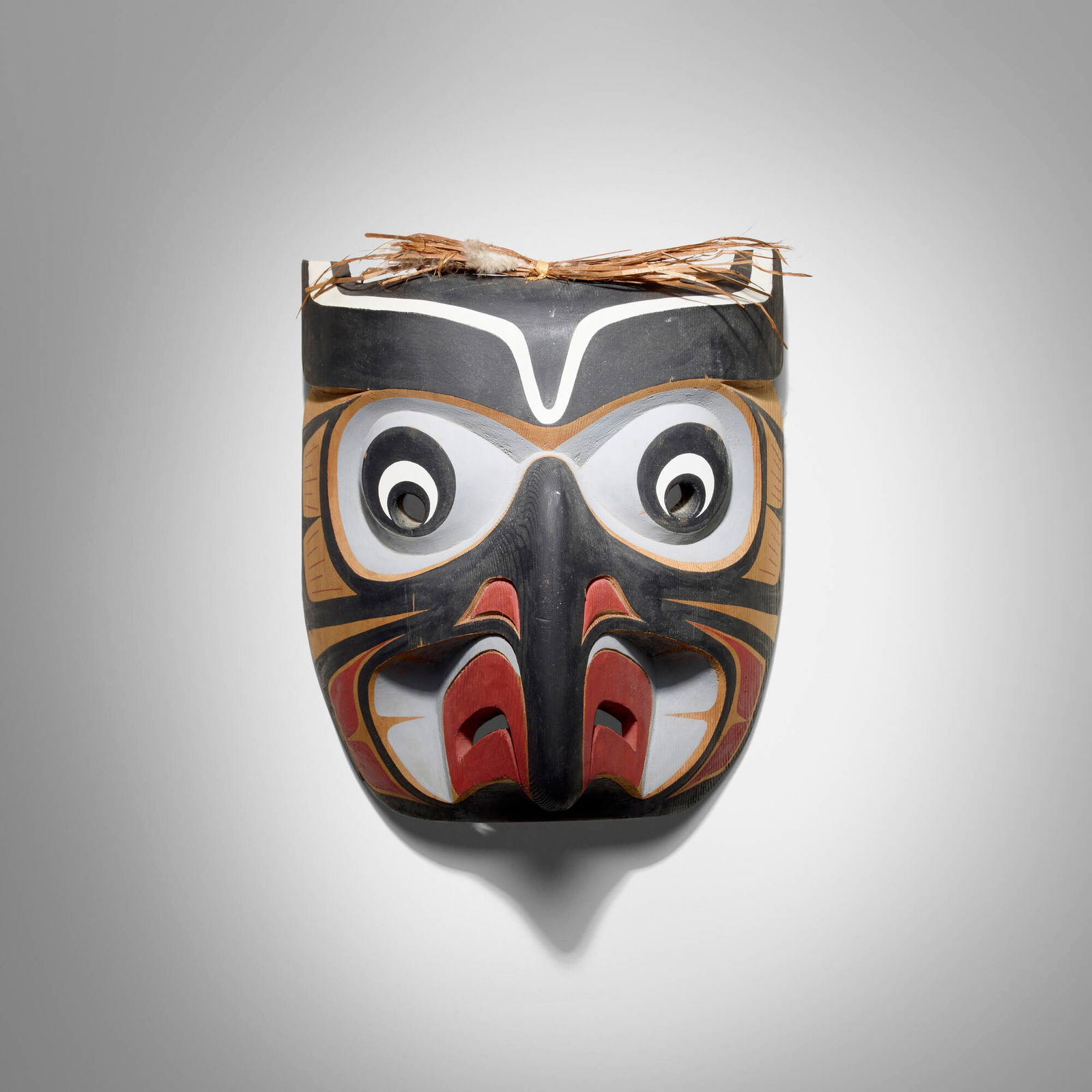 Kwakwaka'wakw (Kwakiutl/Kwagiulth), Owl mask: Kwakwaka'wakw (Kwakiutl/Kwagiulth) Owl mask Northern Vancouver Island, 1988 carved and painted cedar, feathers, raffia 11.5 h x 10.125 w x 6 d in (29 x 26 x 15 cm) Dated and inscribed to reverse