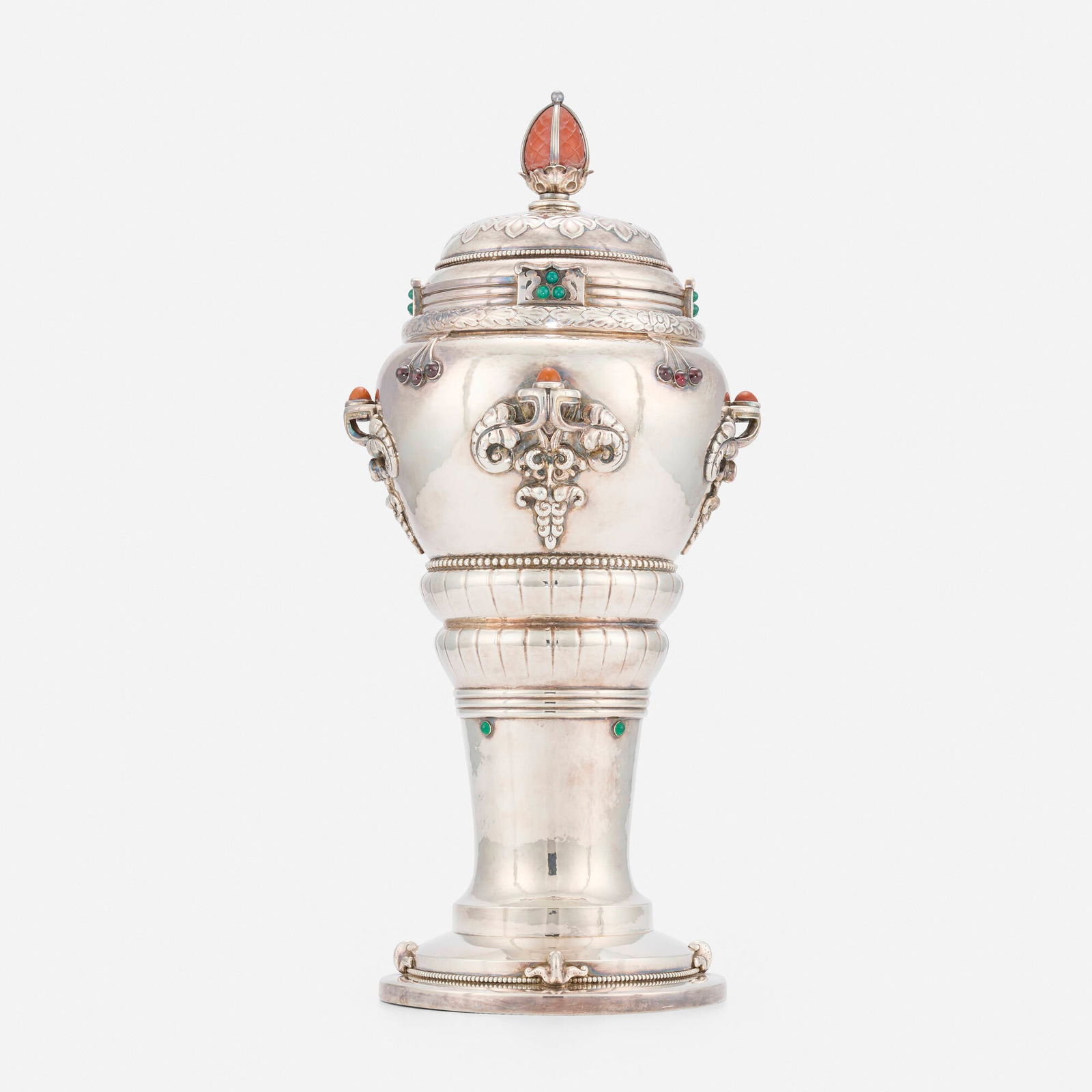 A. Dragsted, Covered vessel with cabochons and pineapple finial: A. Dragsted Covered vessel with cabochons and pineapple finial Denmark, 1909 silver, hardstone, coral, chrysoprase and garnet 17 h x 7.5 dia in (43 x 19 cm) Impressed maker's mark to underside of