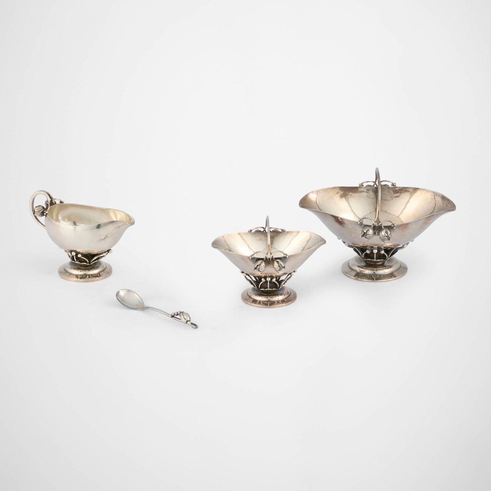 Georg Jensen, Collection of table articles: Georg Jensen Collection of table articles Georg Jensen Denmark, c. 1925-1950 sterling silver largest: 3.75 h x 5.25 w x 3.75 d in (10 x 13 x 10 cm) smallest: 2.75 h x 4 w x 2 d in (7 x 10 x 5 cm) 