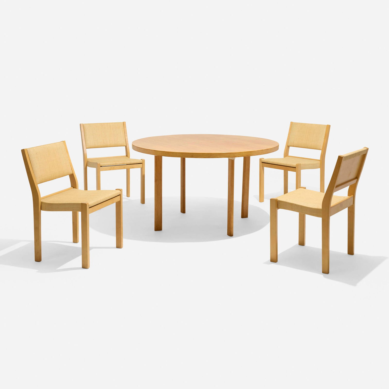Alvar Aalto, Dining suite: Alvar Aalto Dining suite Finland, 1929, c. 1965 / c. 1955 ash, birch, woven raffia upholstery chair: 31.25 h x 19.25 w x 20 d in (79 x 49 x 51 cm) table: 28.125 h x 49 dia in (71 x 124 cm) Suite