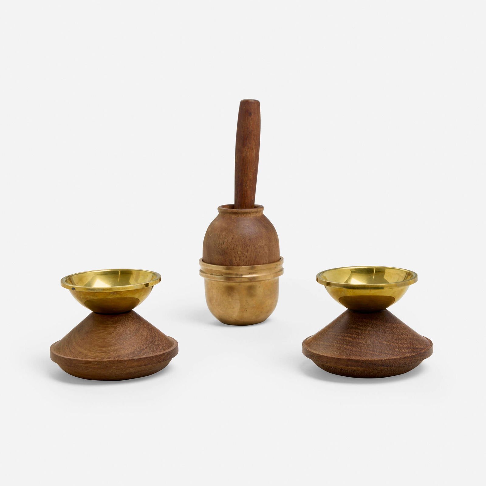 Bertel Gardberg, Table accessories: Bertel Gardberg Table accessories Boda Finland, c. 1956 teak, brass mortar and pestle: 8.5 h x 3.25 dia in (22 x 8 cm) candlestick: 3.125 h x 4 dia in (8 x 10 cm) Lot is comprised of a mortar and