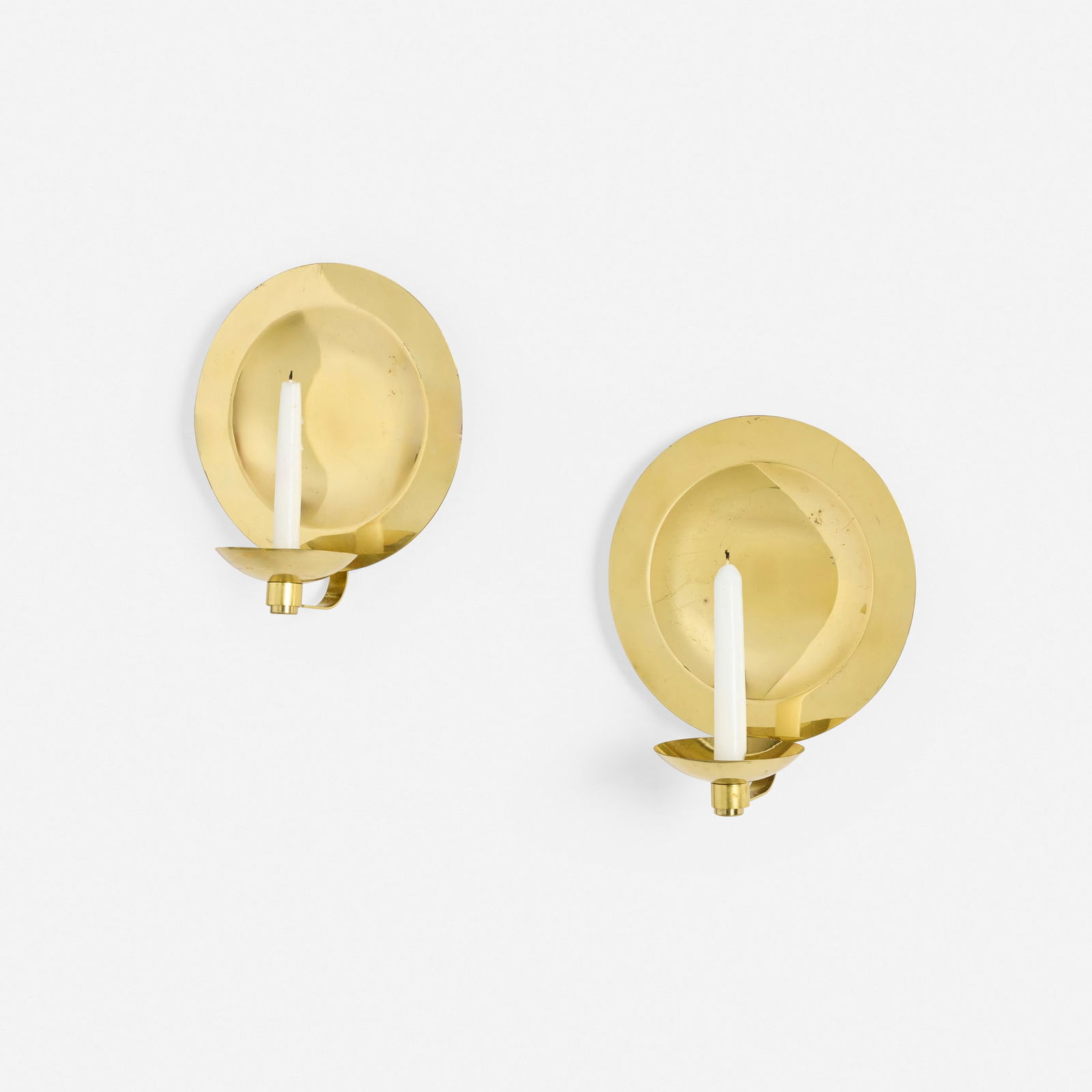 Kaija Aarikka, Uusikuu candle wall sconces, pair: Kaija Aarikka Uusikuu candle wall sconces, pair Aarikka Oy Finland, 1974 brass 10.25 h x 8.875 w x 5.5 d in (26 x 23 x 14 cm) Impressed manufacturer's mark to reverse of each armature 'Aarikka