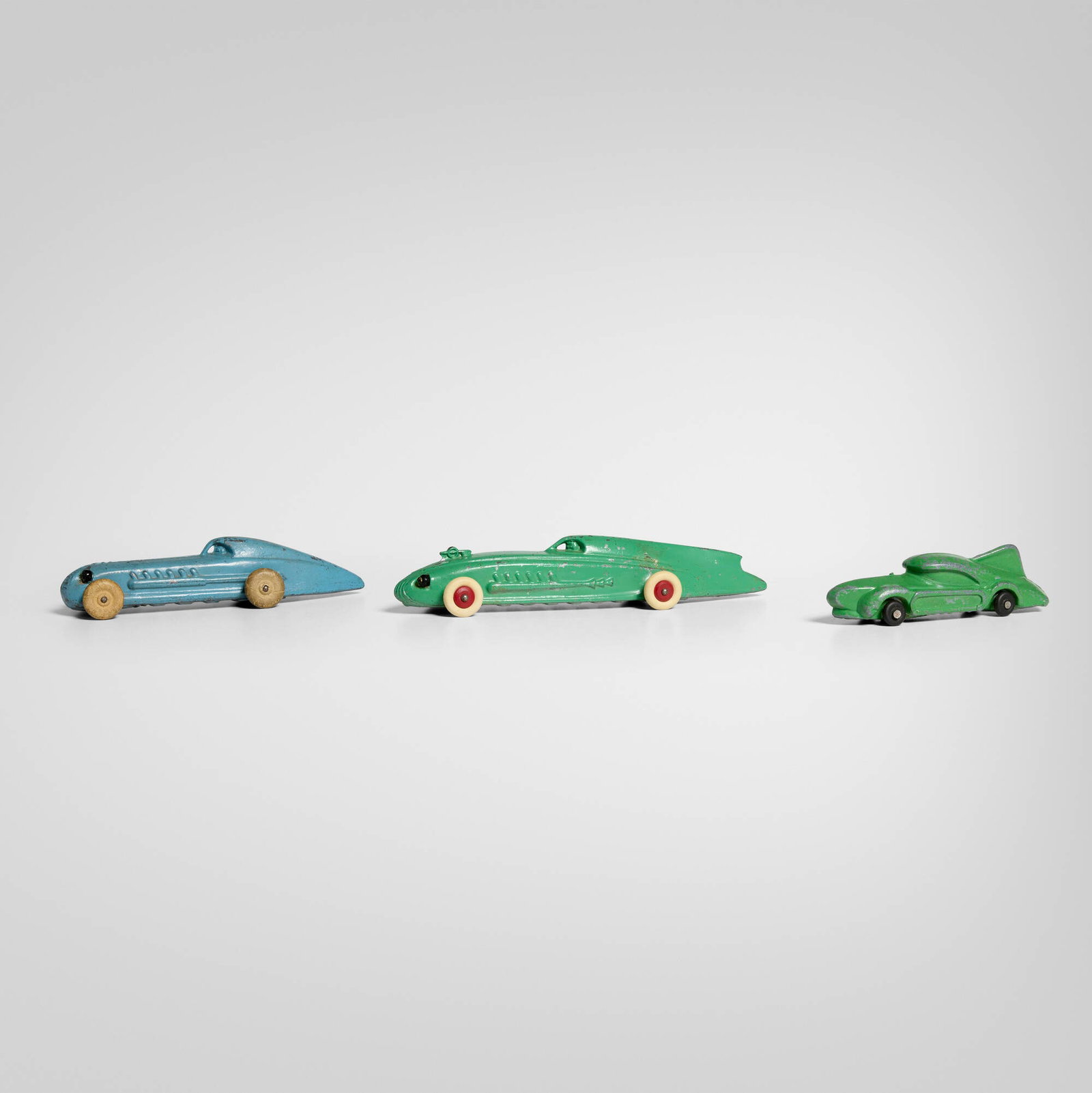 Machine Age, Toy cars, set of three: Machine Age Toy cars, set of three USA, c. 1940painted aluminum, rubber 1.25 h x 4 w x 1.25 d in (3 x 10 x 3 cm) 1.25 h x 5 w x 1.5 d in (3 x 13 x 4 cm) 1.25 h x 7 w x 2 d in (3 x 18 x 5 cm)