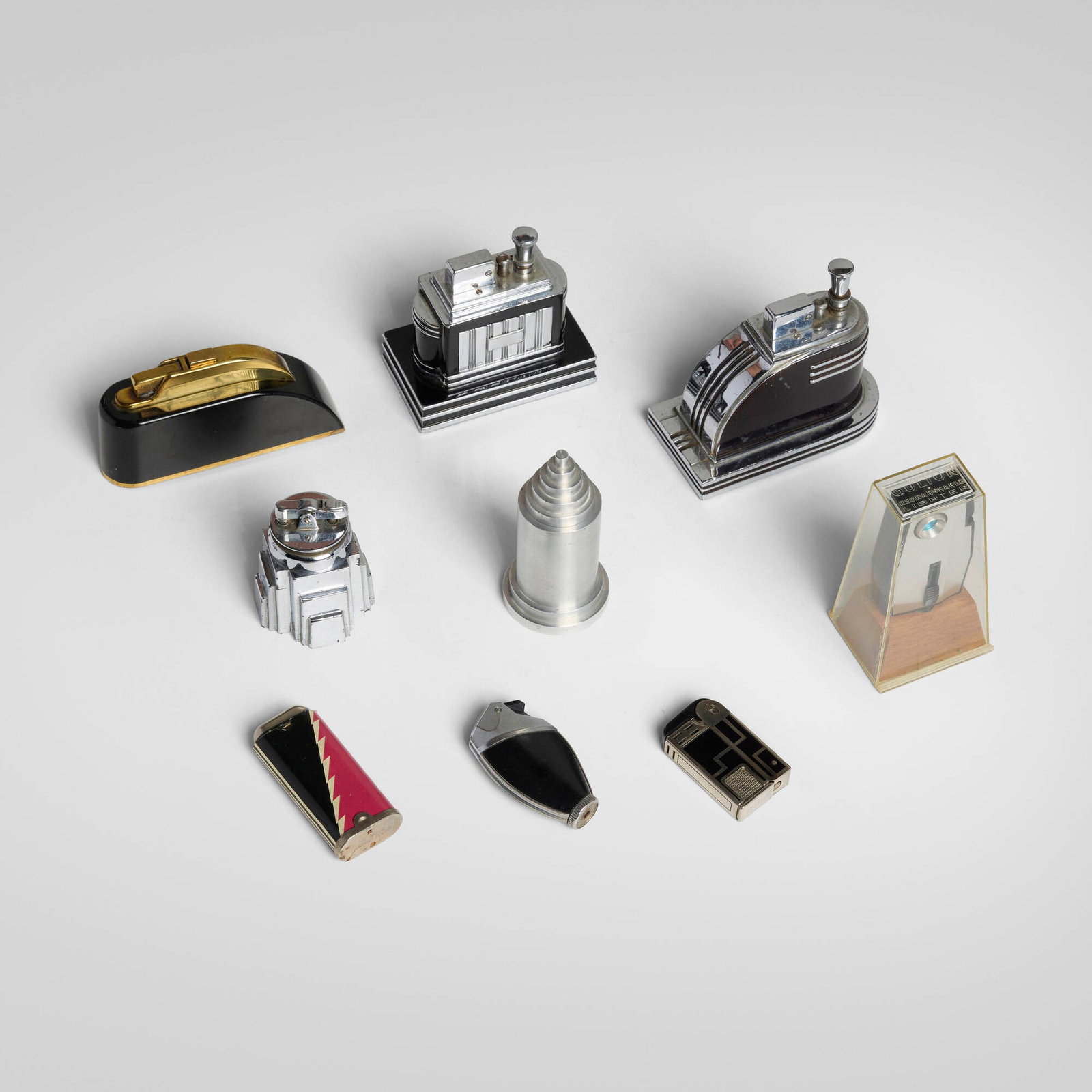 Art Deco, Collection of nine table and pocket lighters: Art Deco Collection of nine table and pocket lighters c. 1925-1938 chrome-plated metal, aluminum, lacquer, enamel, brass, painted steel largest: 3.75 h x 4.5 w x 2.5 d in (10 x 11 x 6 cm) smallest: