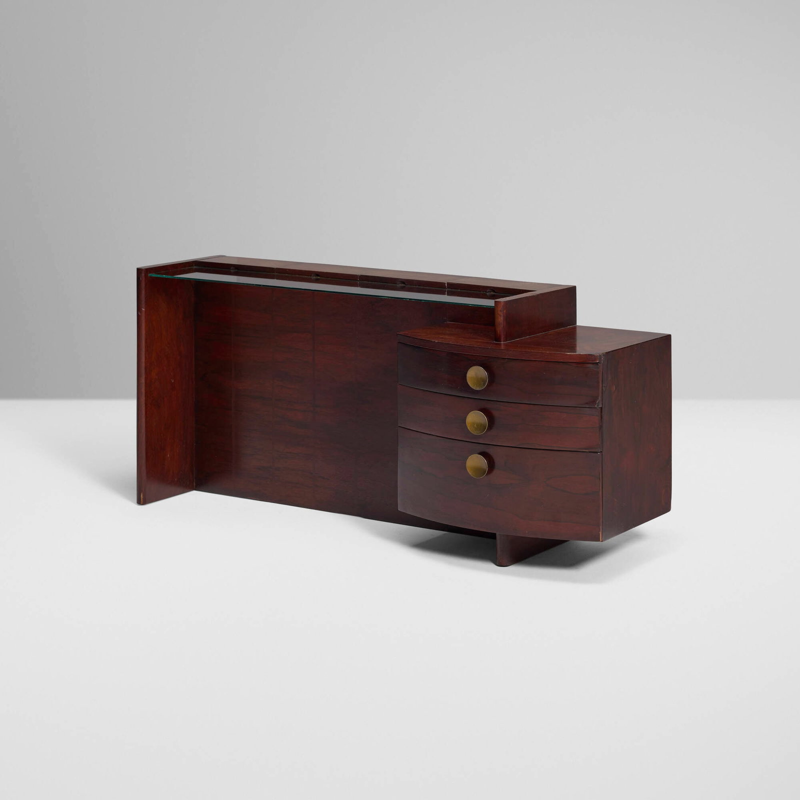 Gilbert Rohde, No. 3770 Group vanity: Gilbert Rohde No. 3770 Group vanity Herman MillerUSA, c. 1940rosewood, brass, glass 26.5 h x 55.5 w x 18.5 d in (67 x 141 x 47 cm) Vanity features four flip-top storage compartments abov