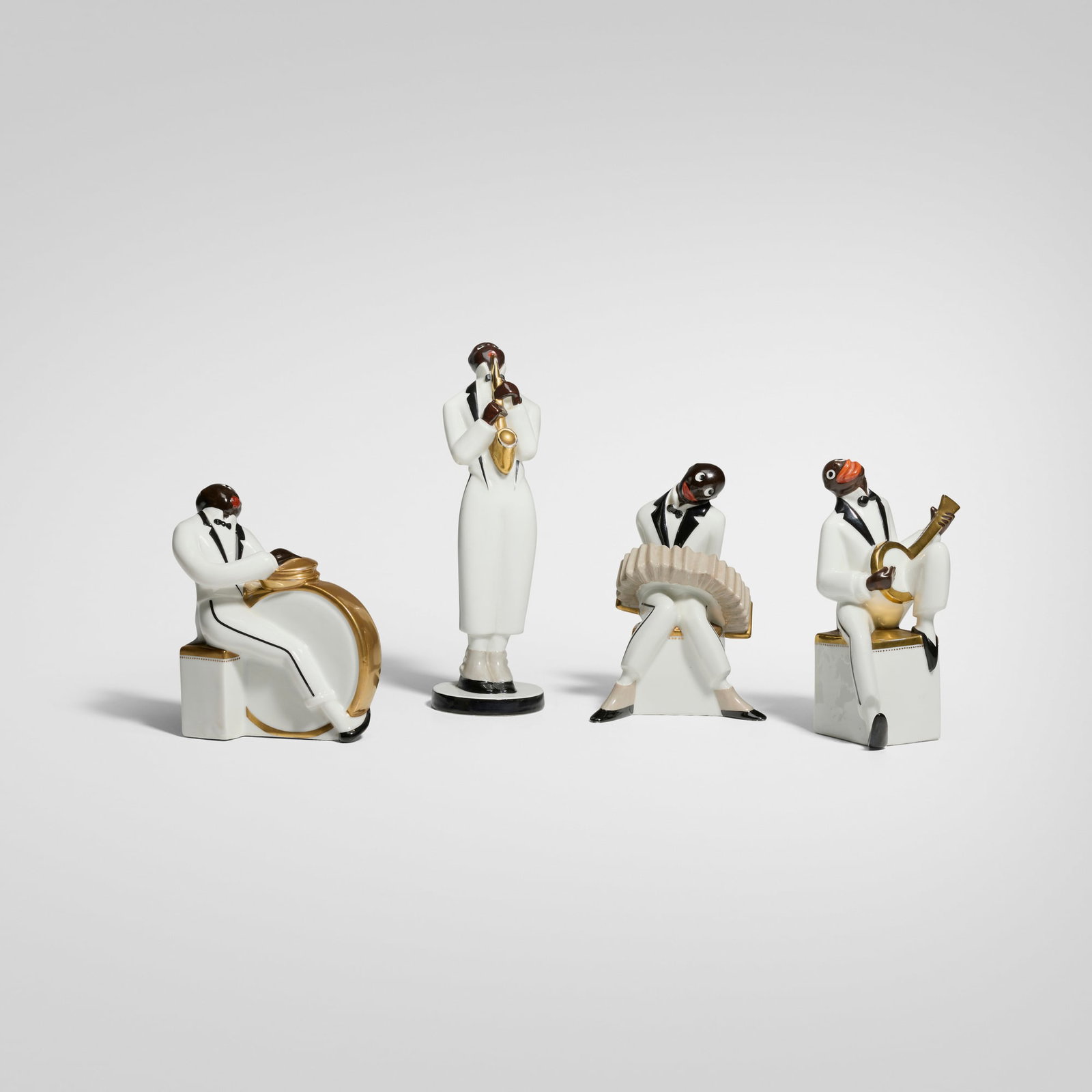 Robj, Jazz quartet figurines: Robj Jazz quartet figurines France, c. 1927 glazed, gilt, and painted porcelain 10.25 h x 3.125 w x 4.5 d in (26 x 8 x 11 cm) 6.875 h x 4.75 w x 4.375 d in (17 x 12 x 11 cm) Figurines include a