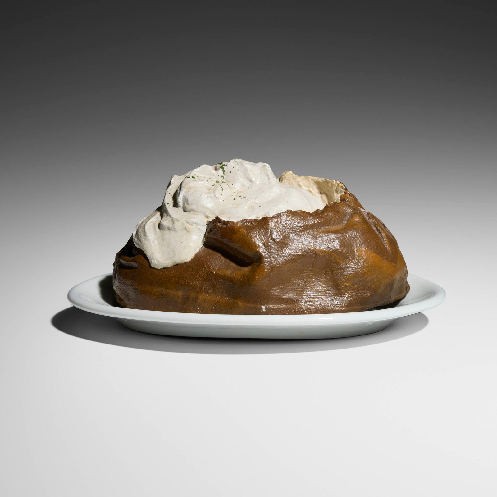 Claes Oldenburg, Baked Potato (from 7 Objects in a Box): Claes Oldenburg Baked Potato (from 7 Objects in a Box) 1966hand-painted cast aluminum; Shenango porcelain potato: 4 h x 8.25 w x 4.75 d in (10 x 21 x 12 cm) plate: 1.125 h x 10.5 w x 7.125 d in (3