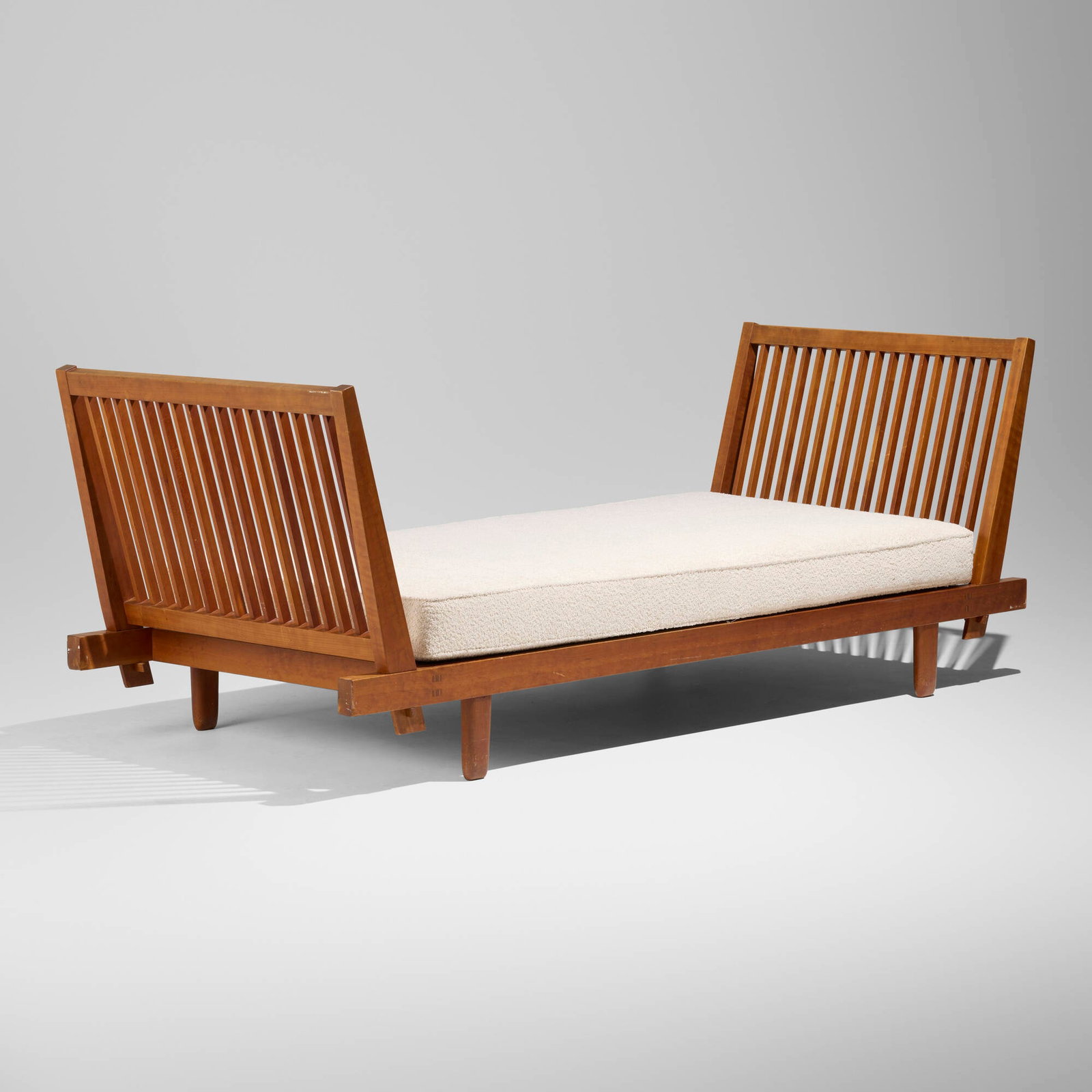 George Nakashima, Special-order bed frame: George Nakashima Special-order bed frame Nakashima Studio USA, 1961 cherry, upholstery 33 h x 89 w x 36 d in (84 x 226 x 91 cm) Sold with a digital copy of the original order card. Provenance: