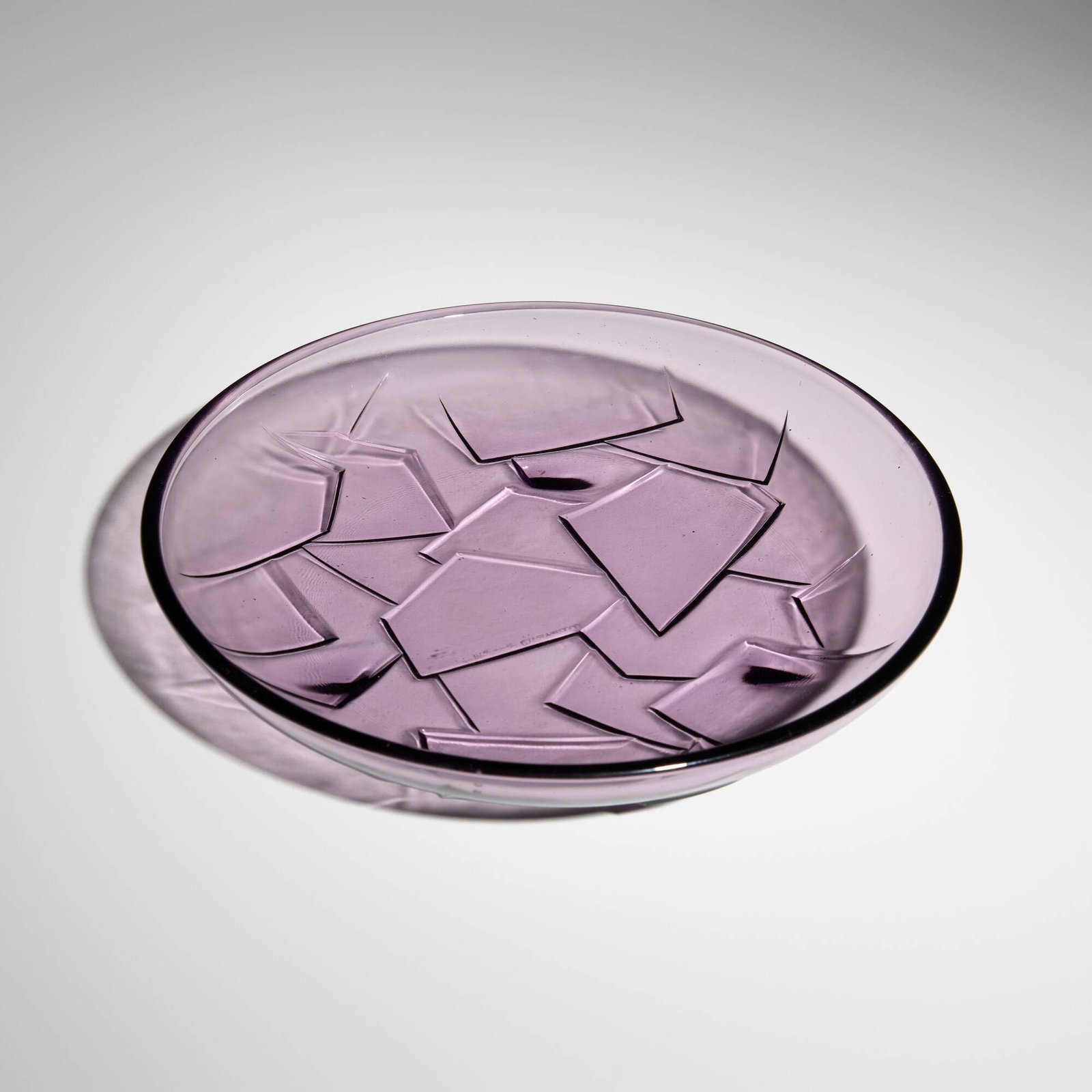 Pierre Chareau, Plate: Pierre Chareau Plate France, c. 1930 molded glass 1.5 h x 8.5 dia in (4 x 22 cm) Incised signature to underside 'Pierre Chareau' with molded manufacturer's mark. Provenance: Private Collection 