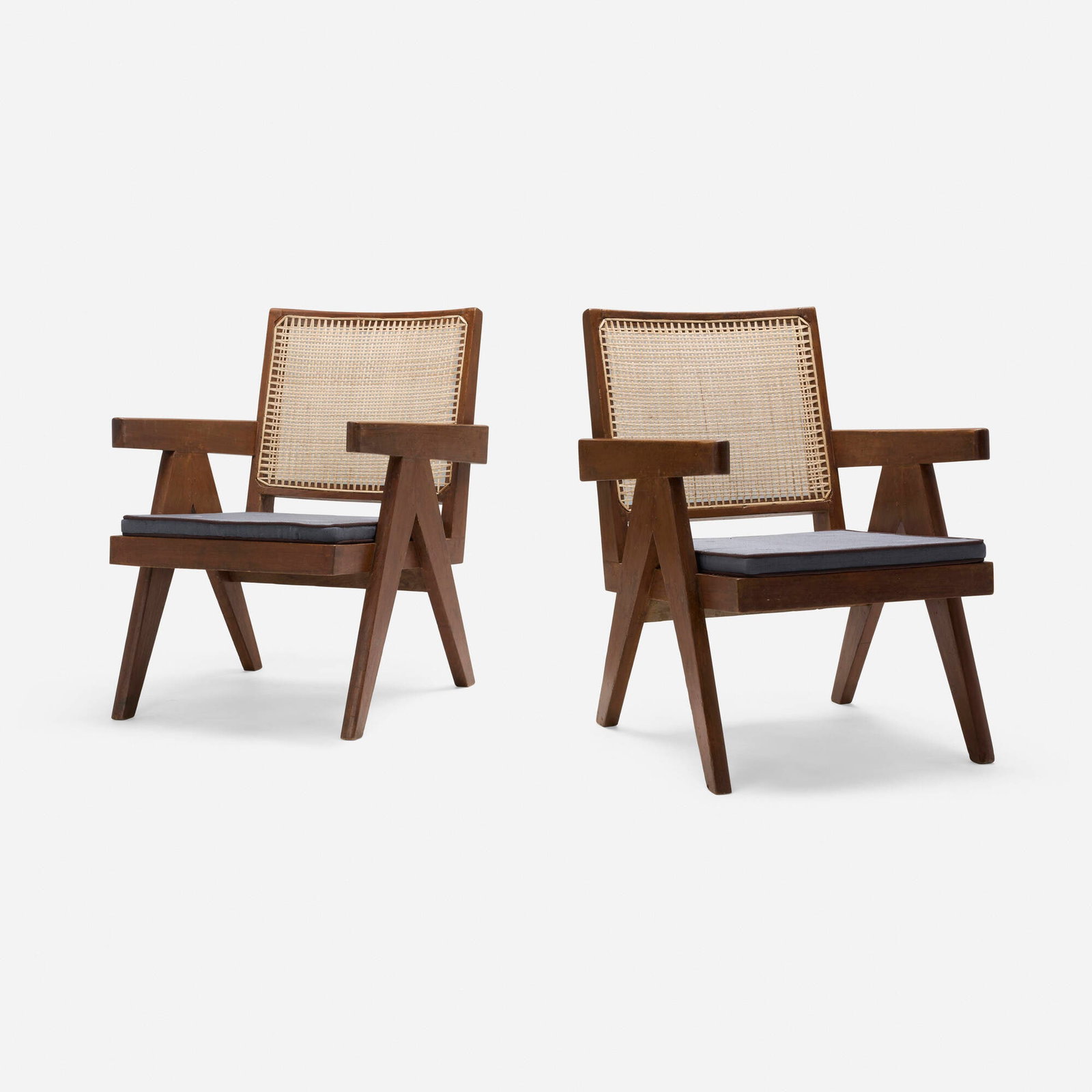 Pierre Jeanneret, Lounge chairs from Punjab Engineering College, Chandigarh, pair: Pierre Jeanneret Lounge chairs from Punjab Engineering College, Chandigarh, pair France/India, c. 1955teak, cane, linen upholstery 30.25 h x 20.75 w x 27 d in (77 x 53 x 69 cm) Provena