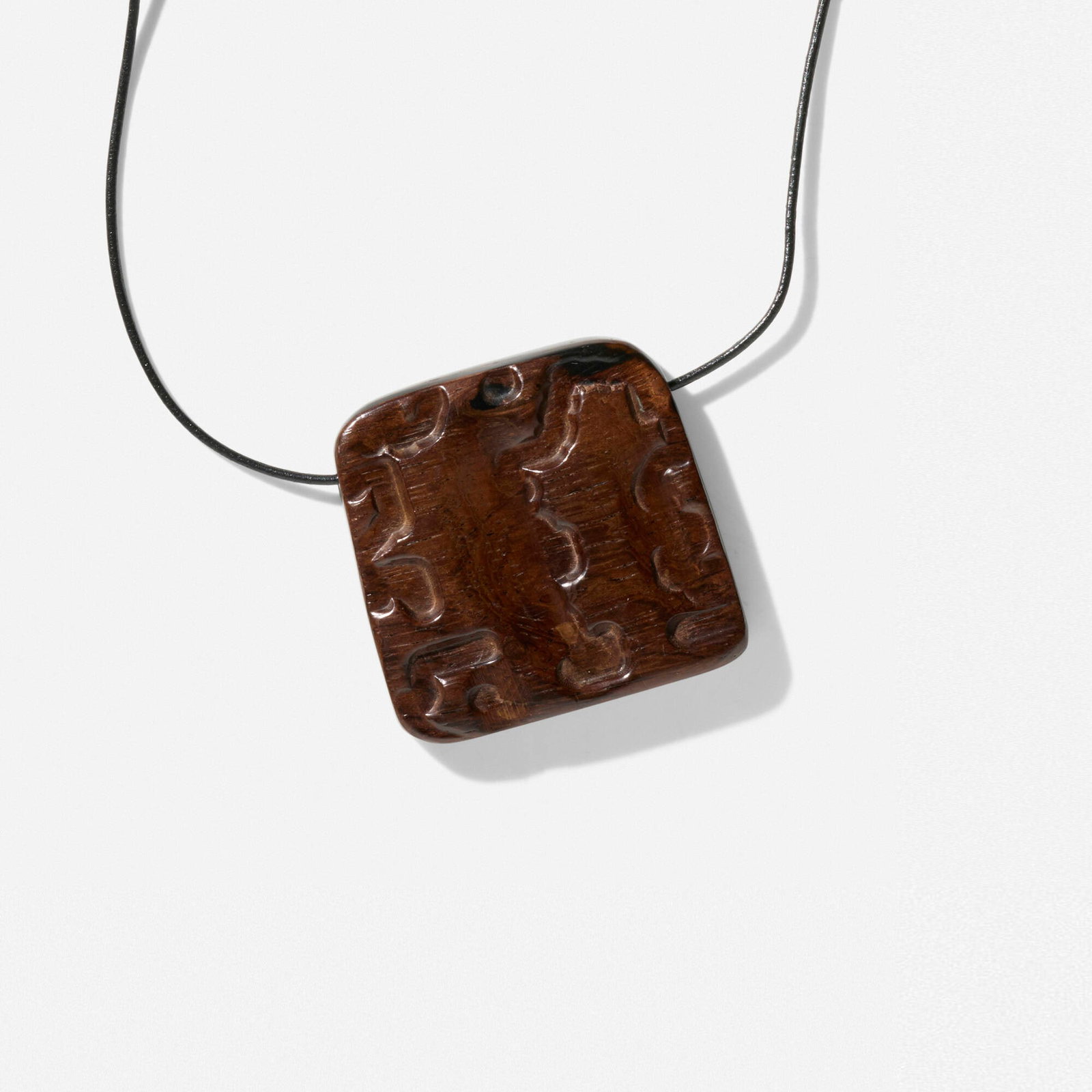 Alexandre Noll, Necklace: Alexandre Noll Necklace France, c. 1960 carved ebony, leather pendant: 2.375 h x 2.5 w x 0.375 d in (6 x 6 x 1 cm) Provenance: Antiquites, Paris | Collection of Michelle Smith | Sotheby's,