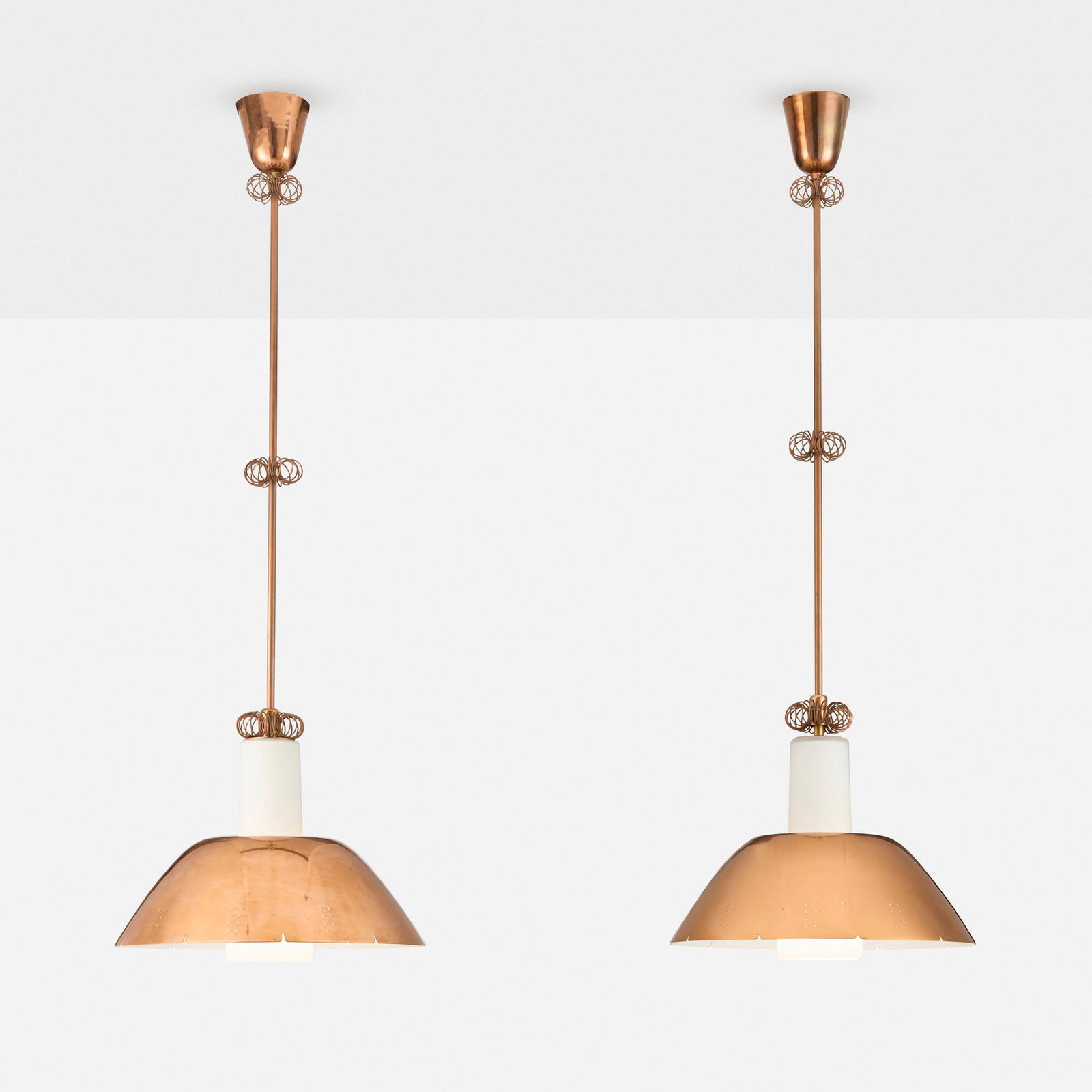 Paavo Tynell, Pendant lamps model K2-20, pair: Paavo Tynell Pendant lamps model K2-20, pair IdmanFinland, c. 1954perforated brass, opaline glass 42.5 h x 14.25 dia in (108 x 36 cm) Impressed manufacturer's mark to each stem 'Idman'.<