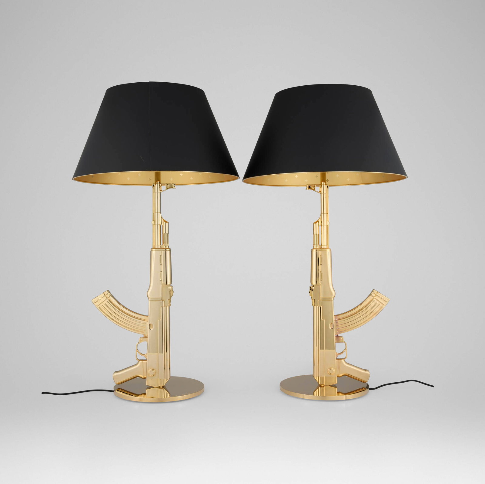 Philippe Starck, Gun table lamps, pair: Philippe Starck Gun table lamps, pair Flos France / Italy, 2005 gilt aluminum with polymer coating, gilt steel 36.5 h x 20 dia in (93 x 51 cm) Printed manufacturer's mark to underside of each