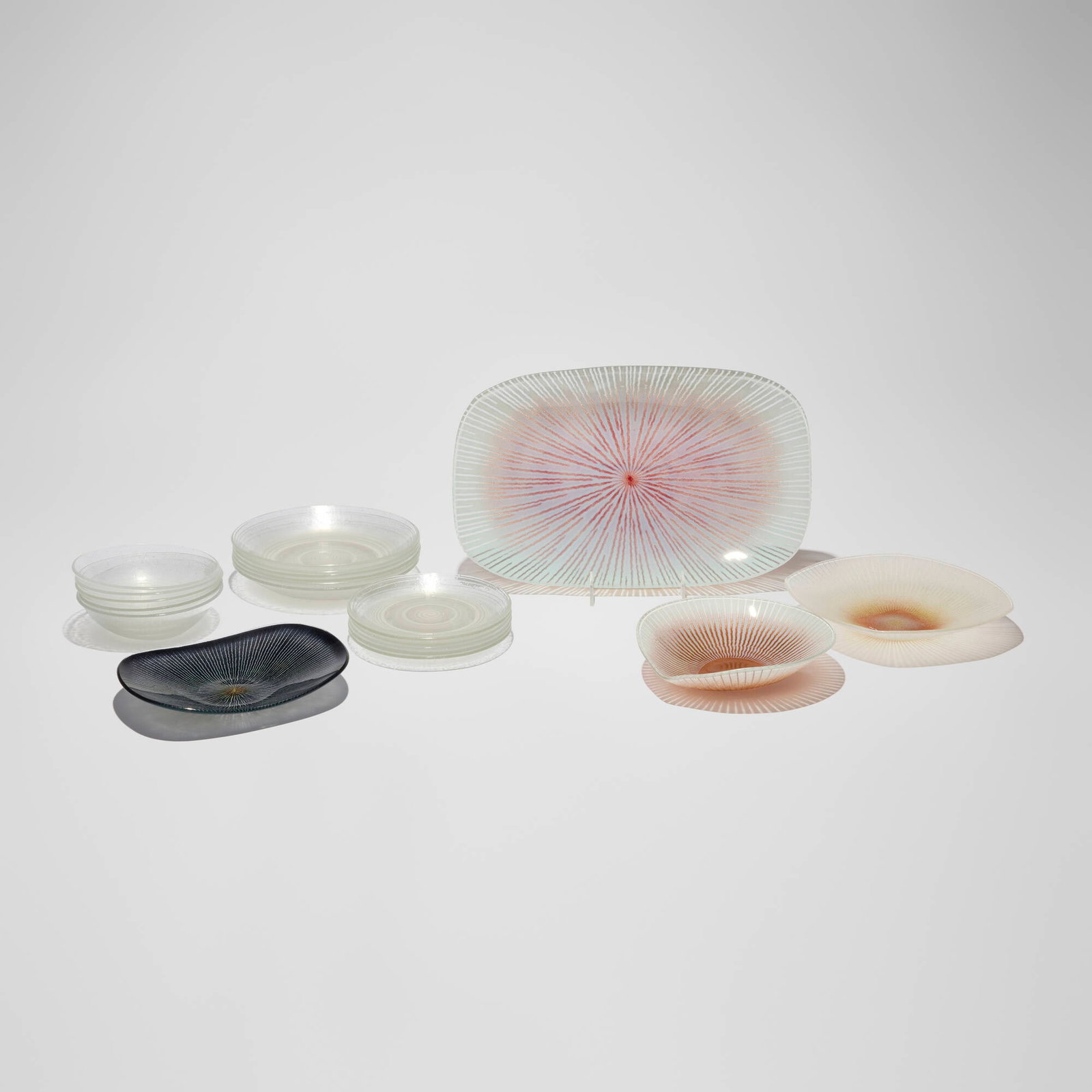 Maurice Heaton, Collection of twenty-one tablewares: Maurice Heaton Collection of twenty-one tablewares c. 1975 fused glass with enamel largest: 1.25 h x 14.5 w x 9.125 d in (3 x 37 x 23 cm) smallest: 0.5 h x 6 dia in (1 x 15 cm) Collection is