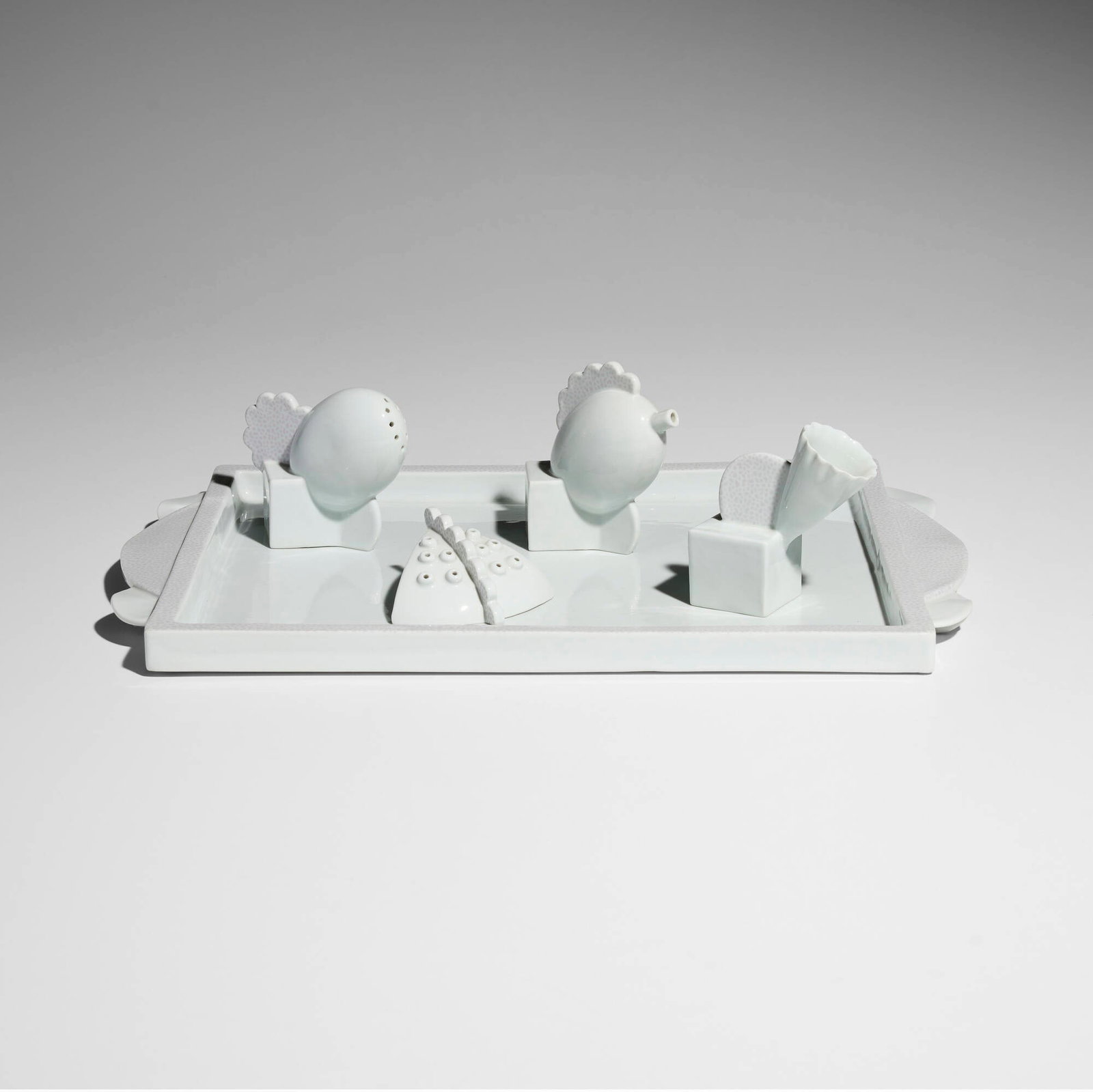 Matteo Thun, Collection of five table accessories: Matteo Thun Collection of five table accessories Memphis Italy, 1982 porcelain largest: 0.75 h x 11 w x 17 d in (2 x 28 x 43 cm) smallest: 1.5 h x 3.25 w x 3.5 d in (4 x 8 x 9 cm) Collection includes