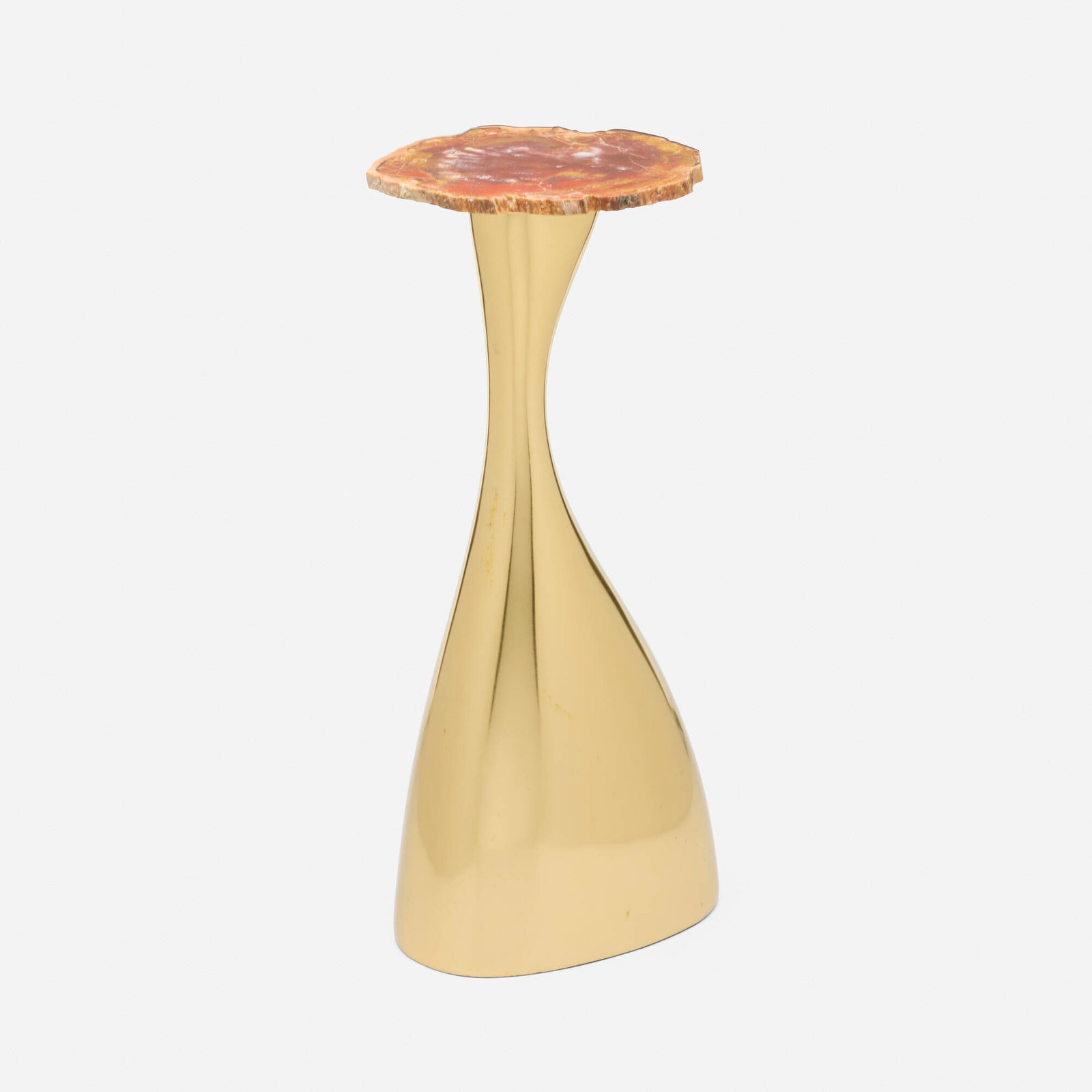 In the manner of Philippe Hiquilly, Occasional table: In the manner of Philippe Hiquilly Occasional table Late 20th century polished brass-finished steel, petrified wood 18 h x 8.75 w x 6.875 d in (46 x 22 x 17 cm) This work will ship from Lambertville,