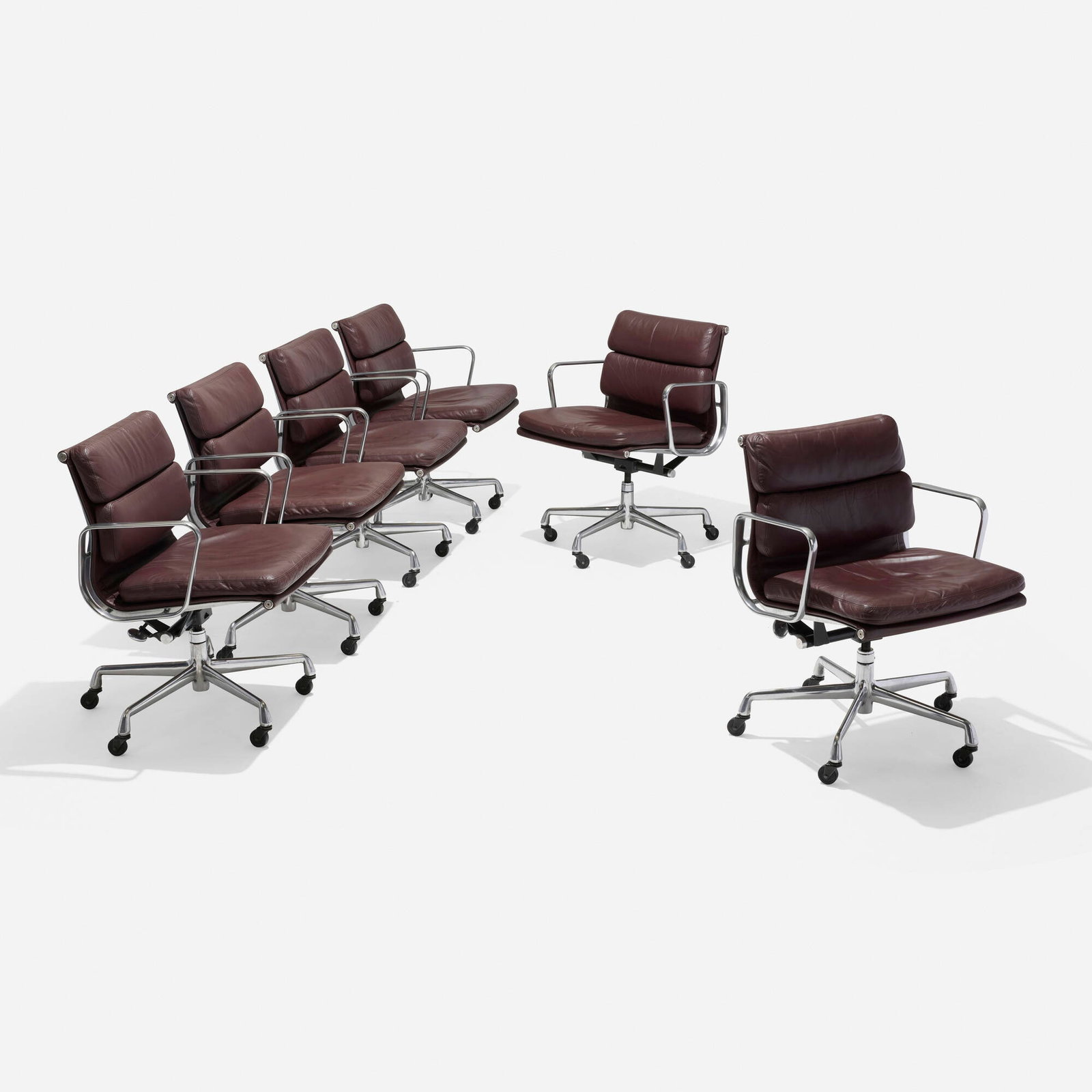 Charles and Ray Eames, Soft Pad Management chairs, set of six: Charles and Ray Eames Soft Pad Management chairs, set of six Herman Miller USA, 1969 / 2000 polished aluminum, leather upholstery, lacquered steel 33.25 h x 26.5 dia in (84 x 67 cm) Impressed