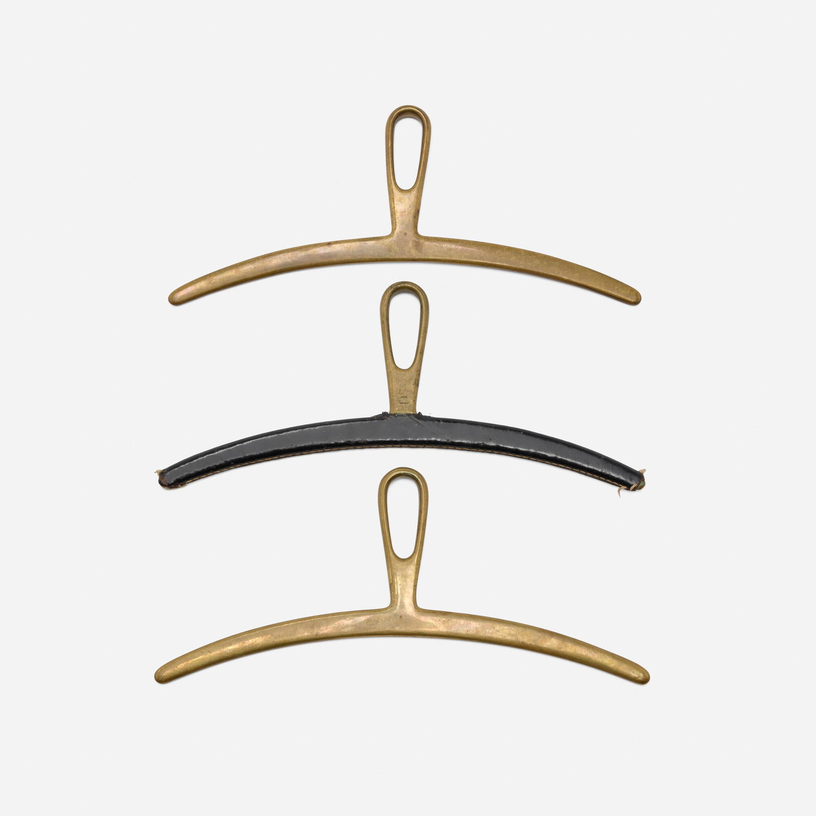 Carl Aubock II, Coat hangers model 3664, set of three: Carl Aubock II Coat hangers model 3664, set of three Werkstatte Carl Aubock Austria, c. 1950 brass, leather 6 h x 14.5 w x 1 d in (15 x 37 x 3 cm) Impressed manufacturer's mark to hook element