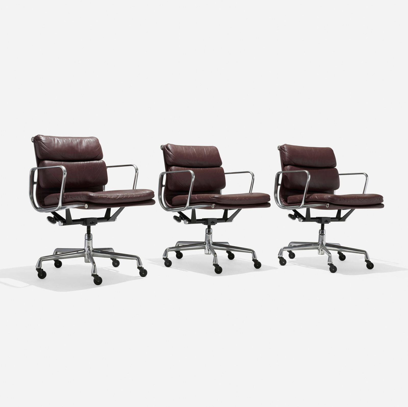 Charles and Ray Eames, Soft Pad Management chairs, set of three: Charles and Ray Eames Soft Pad Management chairs, set of three Herman Miller USA, 1969 / 2000 polished aluminum, leather upholstery, lacquered steel 32.75 h x 26.5 dia in (83 x 67 cm) Impressed