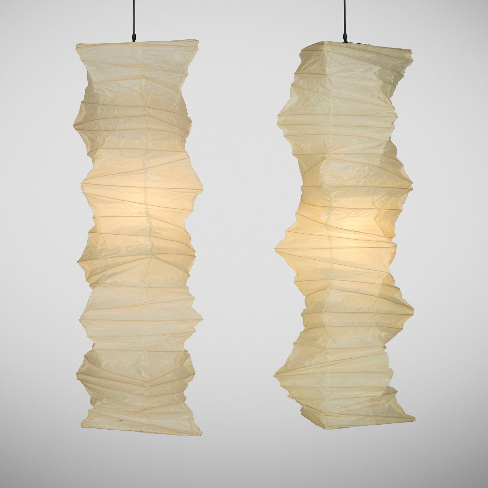 Isamu Noguchi, Akari light sculptures model 33N, pair: Isamu Noguchi Akari light sculptures model 33N, pair Ozeki & Co., Ltd. USA, shade designed 1969 washi paper, bamboo 53 h x 19 dia in (135 x 48 cm) Stamped 'Sun and Moon' ideogram
