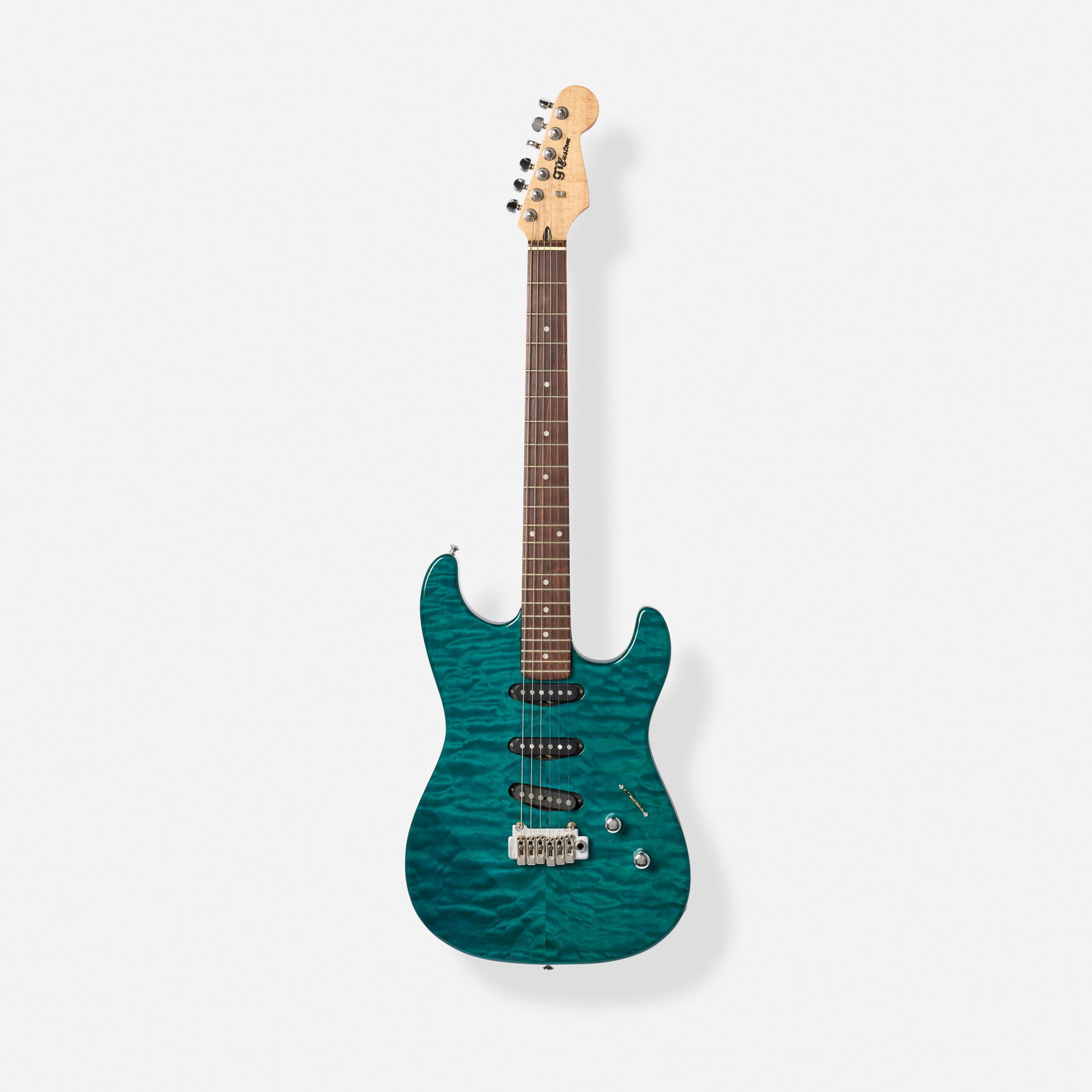 GM Custom, Strat Solidbody Electric Guitar, 1997: GM Custom Strat Solidbody Electric Guitar, 1997 Bakersfield, USA Quilted maple top, flame maple neck, back of headstock inscribed 'Built For Mona: By Gene Moles'. Finish: Teal Serial number: 72