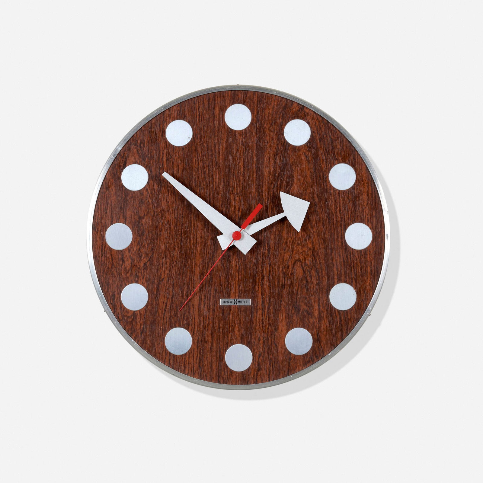 Arthur Umanoff, Meridian wall clock, model 7564: Arthur Umanoff Meridian wall clock, model 7564 Howard Miller Clock Company USA, c. 1950 Aluminum, rosewood 2.75 h x 12.75 dia in (7 x 32 cm) Paper manufacturer's label to reverse 