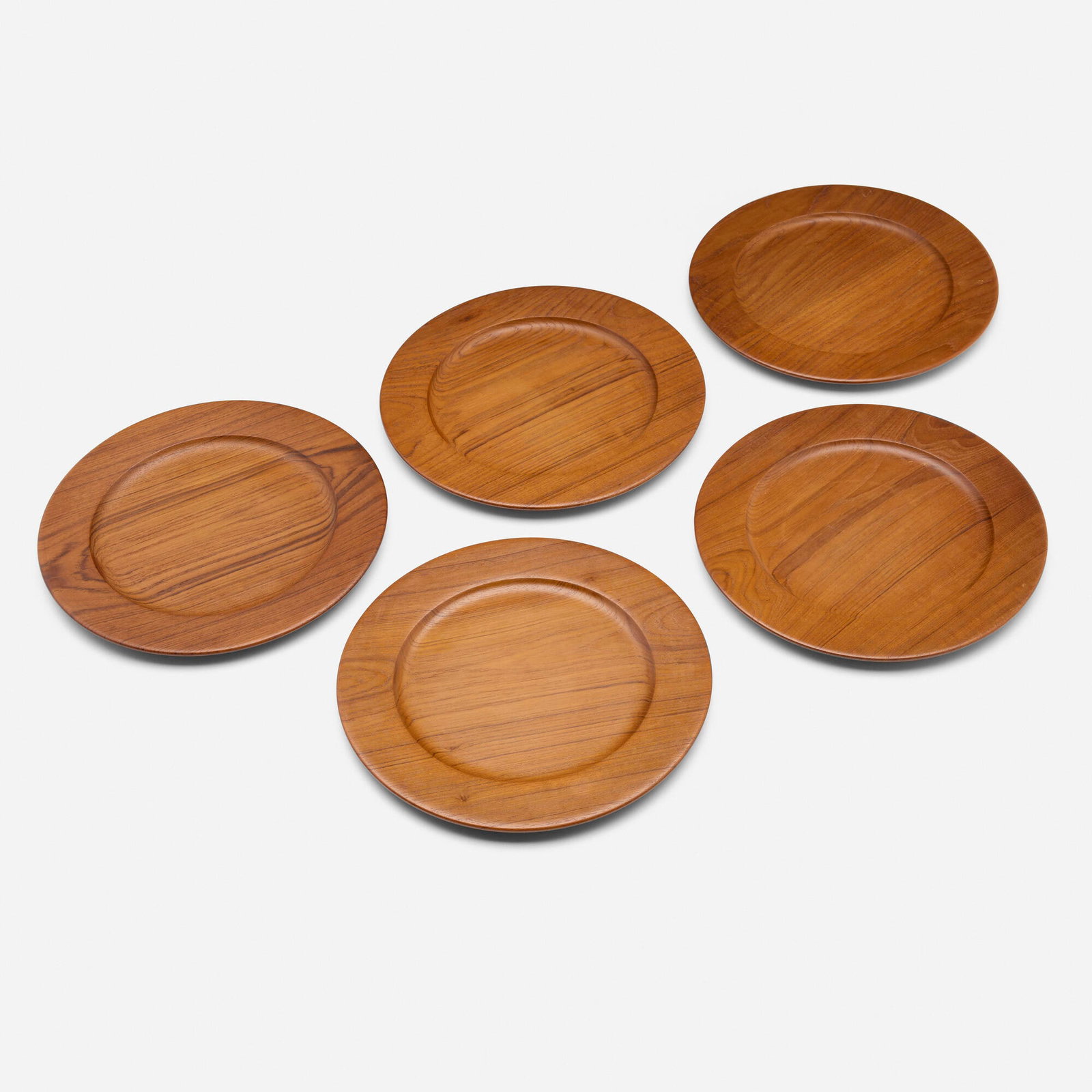 Jens Quistgaard, Plates, set of five: Jens Quistgaard Plates, set of five Wiggers Denmark, c. 1965 teak 0.5 h x 11 dia in (1 x 28 cm) Branded manufacturer's mark to underside of two examples 'W Denmark'. Branded