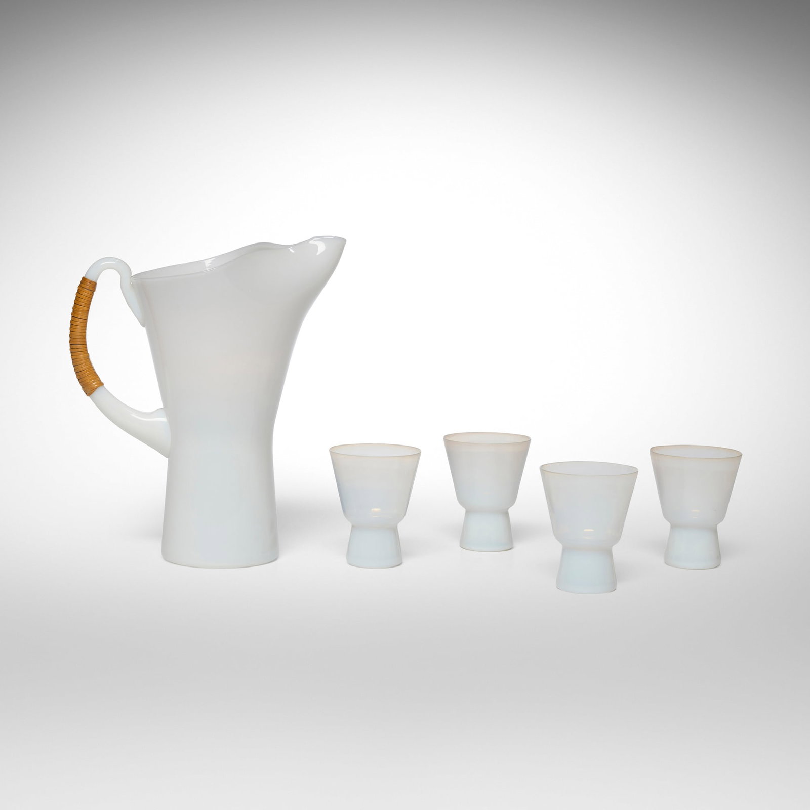 Jacob E. Bang, Pitcher and cups, set of four: Jacob E. Bang Pitcher and cups, set of four Kastrup Glasvaerk Denmark, 1957 opaline glass, cane 8.75 h x 7.5 w x 5 d in (22 x 19 x 13 cm) 3 h x 2.5 dia in (8 x 6 cm) This work will ship from Chicago,