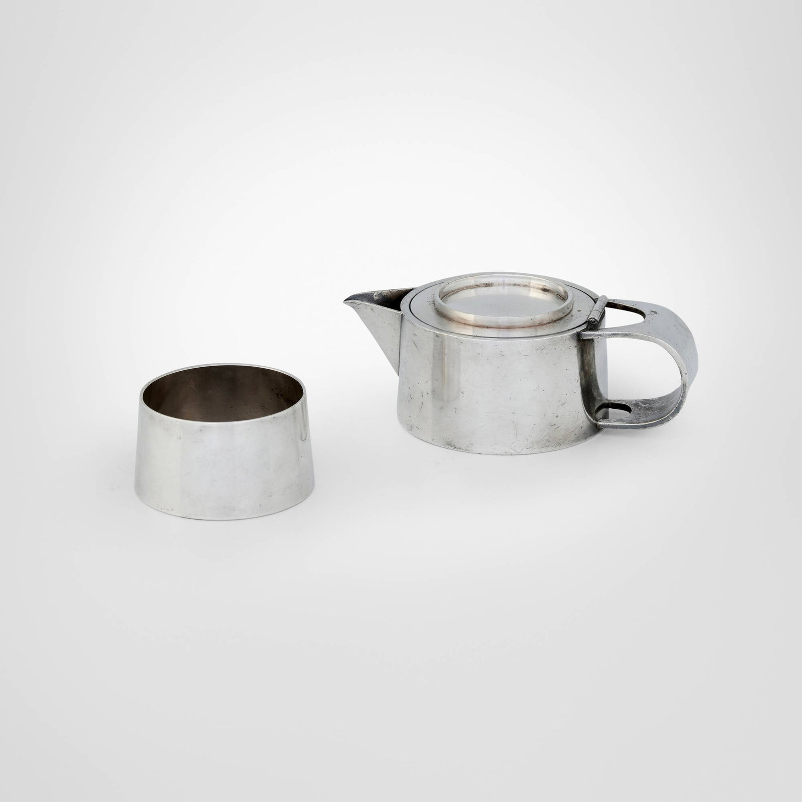 International Silver Company, Creamer and sugar: International Silver Company Creamer and sugar USA, c. 1935 silver-plated brass 2.25 h x 6.25 w x 3.75 d in (6 x 16 x 10 cm) 1.75 h x 3 dia in (4 x 8 cm) Impressed manufacturer's mark t