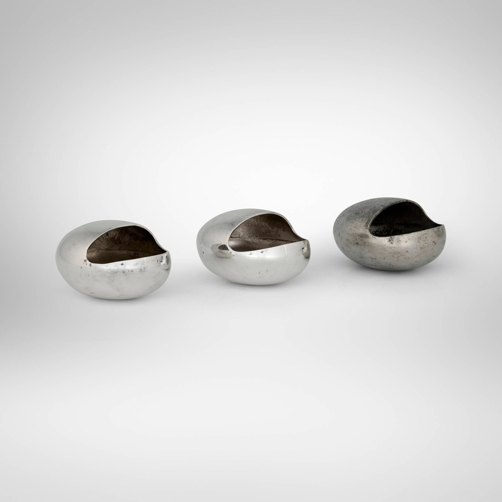 Hans Bunde, Ashtrays, set of three: Hans Bunde Ashtrays, set of three Cohr & Company Aarhus, Denmark, c. 1955 sterling silver, steel 2 h x 3.5 w x 2.75 d in (5 x 9 x 7 cm) Impressed manufacturer's mark to underside of t