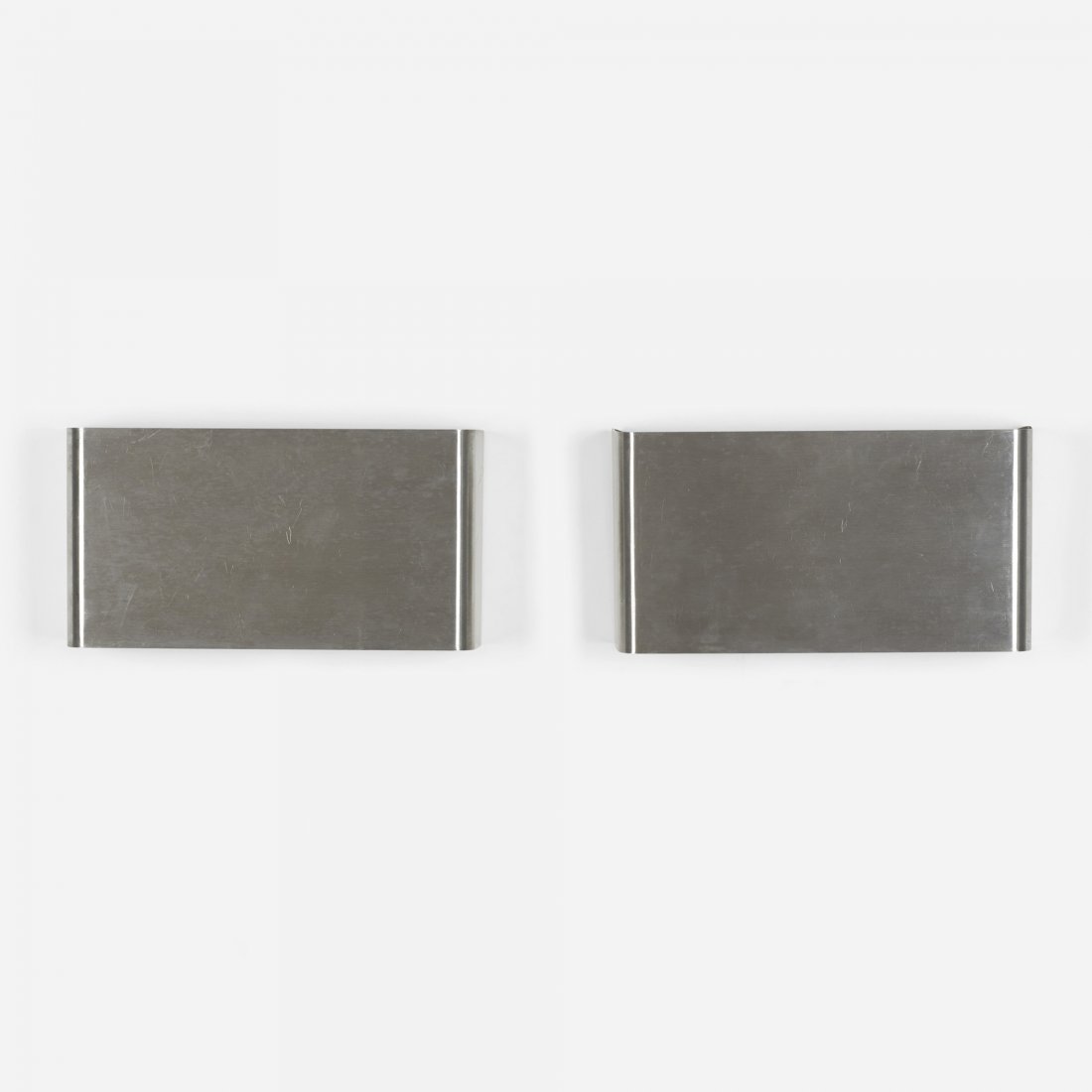 Maison Charles sconces, pair: Maison Charles sconces, pair France, c. 1975 stainless steel 7 w x 3.25 d x 13.5 h inches Signed with impressed manufacturer's mark to reverse of each example: [Charles Made in France].