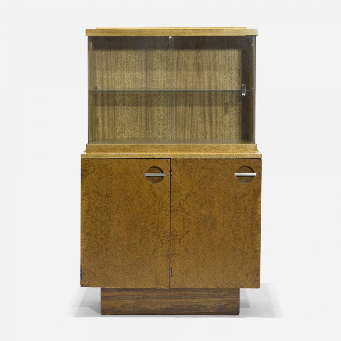 Gilbert Rohde cabinet: Gilbert Rohde cabinet Herman Miller USA, c. 1940 walnut burl, bleached mahogany, glass, nickel-plated steel 36 w x 16.5 d x 58 h inches Cabinet features two glass doors concealing a glass shelf and tw