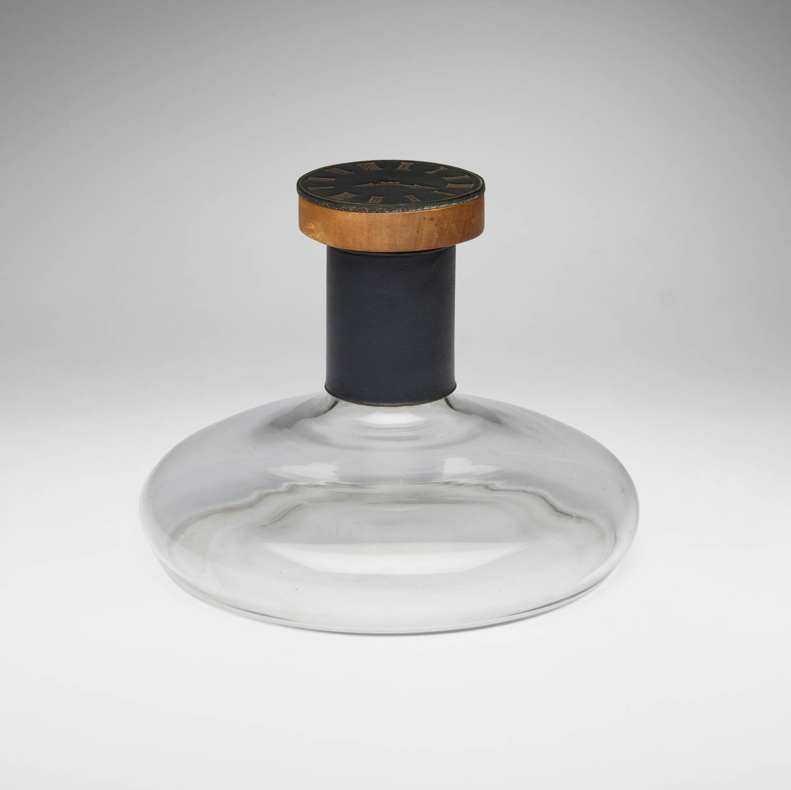 Carl Aubock II, Rare decanter with stopper: Carl Aubock II Rare decanter with stopper Werkstatte Carl Aubock Austria, c. 1950 glass, embossed and gilt leather, cork, mahogany 6.75 h x 8.75 dia in (17 x 22 cm) This rare decanter feat