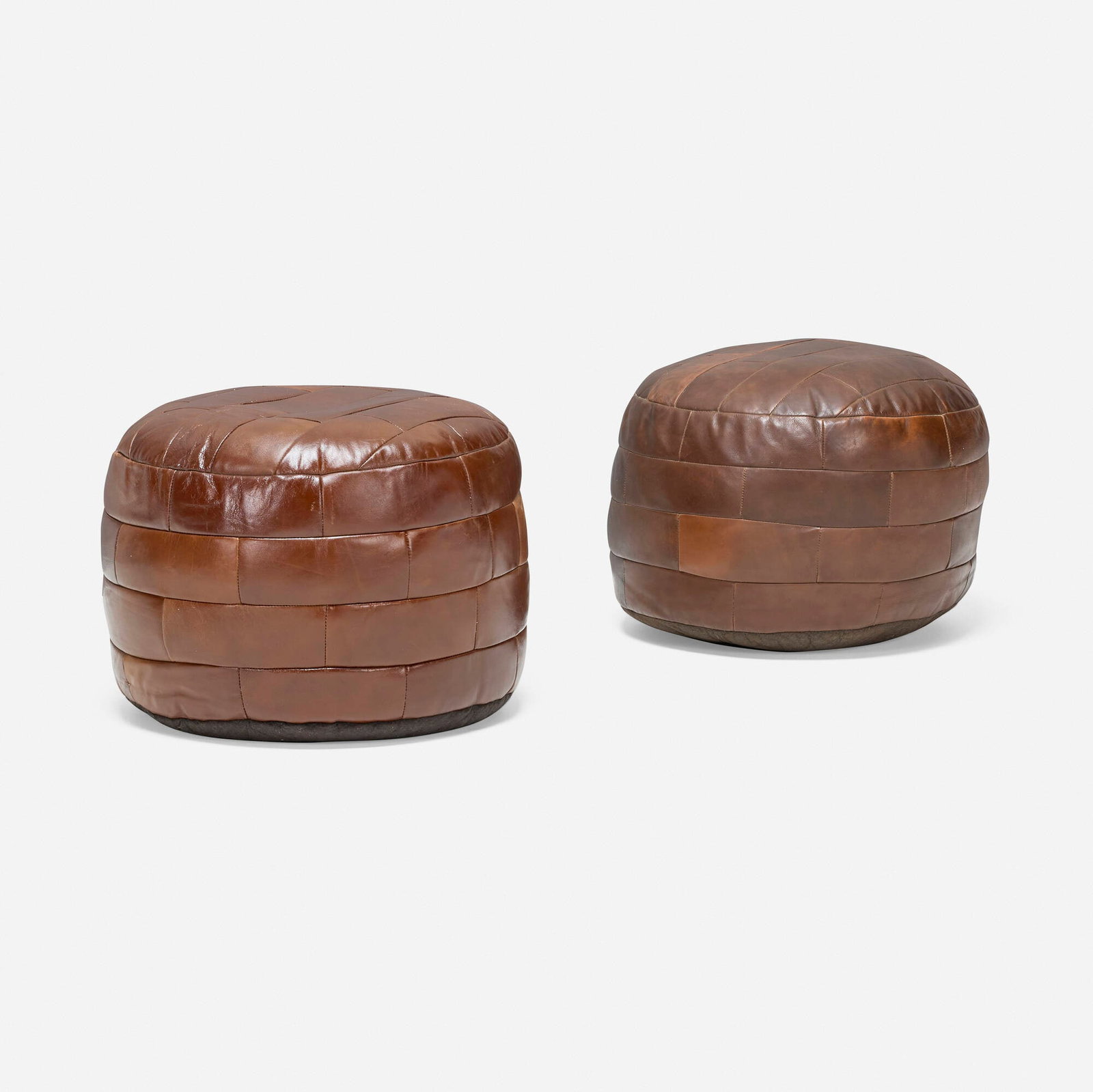 De Sede, DS 80 ottomans, set of two: De Sede DS 80 ottomans, set of two Switzerland, c. 1965 leather upholstery 15.5 h x 19 dia in (39 x 48 cm) This work will ship from Los Angeles, California.