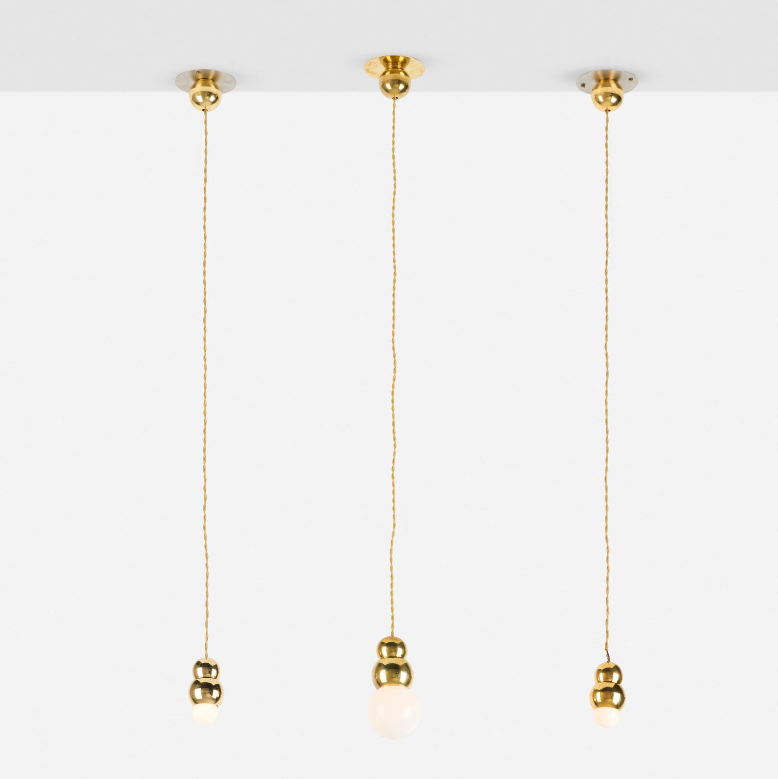 Michael Anastassiades, Ball Light Flex pendant lamps, set of three: Michael Anastassiades Ball Light Flex pendant lamps, set of three England, 2008 / produced later polished brass, glass, zinc, rayon cord 7 h x 4.5 dia in (18 x 11 cm) 4.5 h x 4.5 dia in (11 x 11 cm