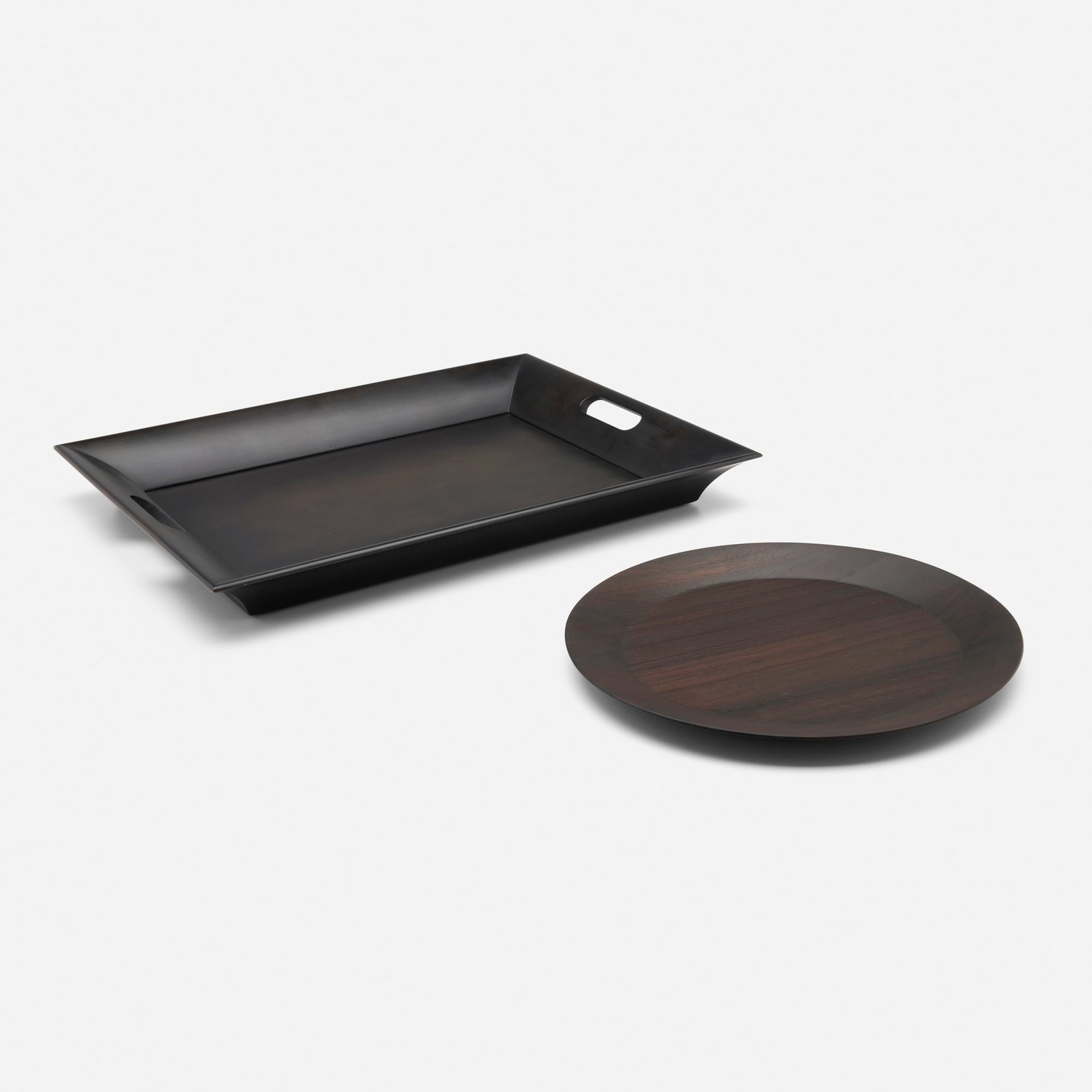 Hermes, Trays, set of two: Hermes Trays, set of two France, c. 1994, c. 2010 lacquered wood, stained rosewood 1.75 h x 17.375 w in (4 x 44 cm) 0.75 h x 13.75 w x 11 dia in (2 x 35 x 28 cm) Lot includes one tray from the H Deco
