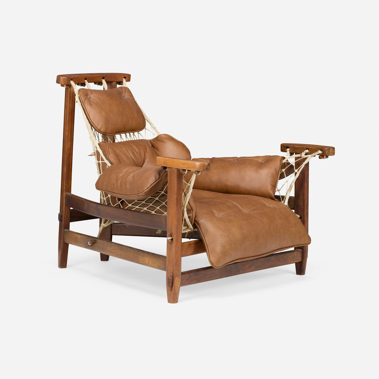 Jean Gillon, Jangada lounge chair: Jean Gillon Jangada lounge chair Italma Wood Art Brazil, 1960 Brazilian rosewood, leather, nylon rope 32.25 h x 35 w x 41.5 d in (82 x 89 x 105 cm) Partial manufacturer's label to inside of one