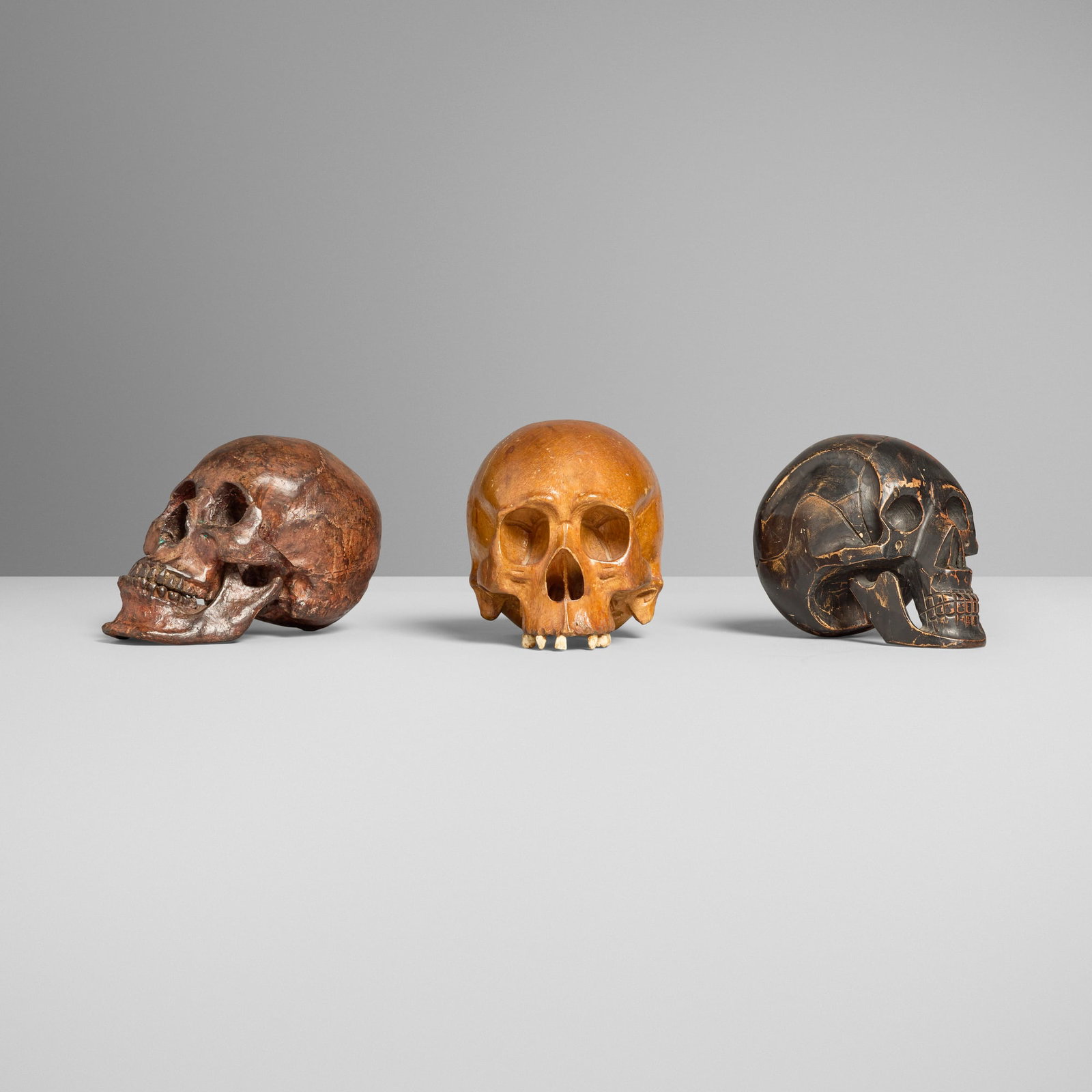 Collection of three memento mori skulls: Collection of three memento mori skulls painted wood, bronze, resin 5.5 h x 5 w x 8 d in (14 x 13 x 20 cm) 6.75 h x 5.5 w x 7.5 d in (17 x 14 x 19 cm) 6 h x 5 w x 7.25 d in (15 x 13 x 18 cm) Collectio
