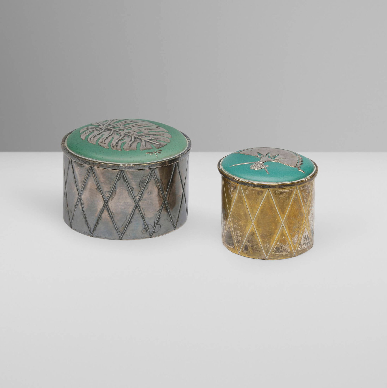 Los Castillo, Lidded boxes, set of two: Los Castillo Lidded boxes, set of two Mexico, c. 1980 silver-plated metal, ceramic 2.5 h x 3.625 dia in (6 x 9 cm) 2.375 h x 2.75 dia in (6 x 7 cm) Set includes one example by Emilia Castil