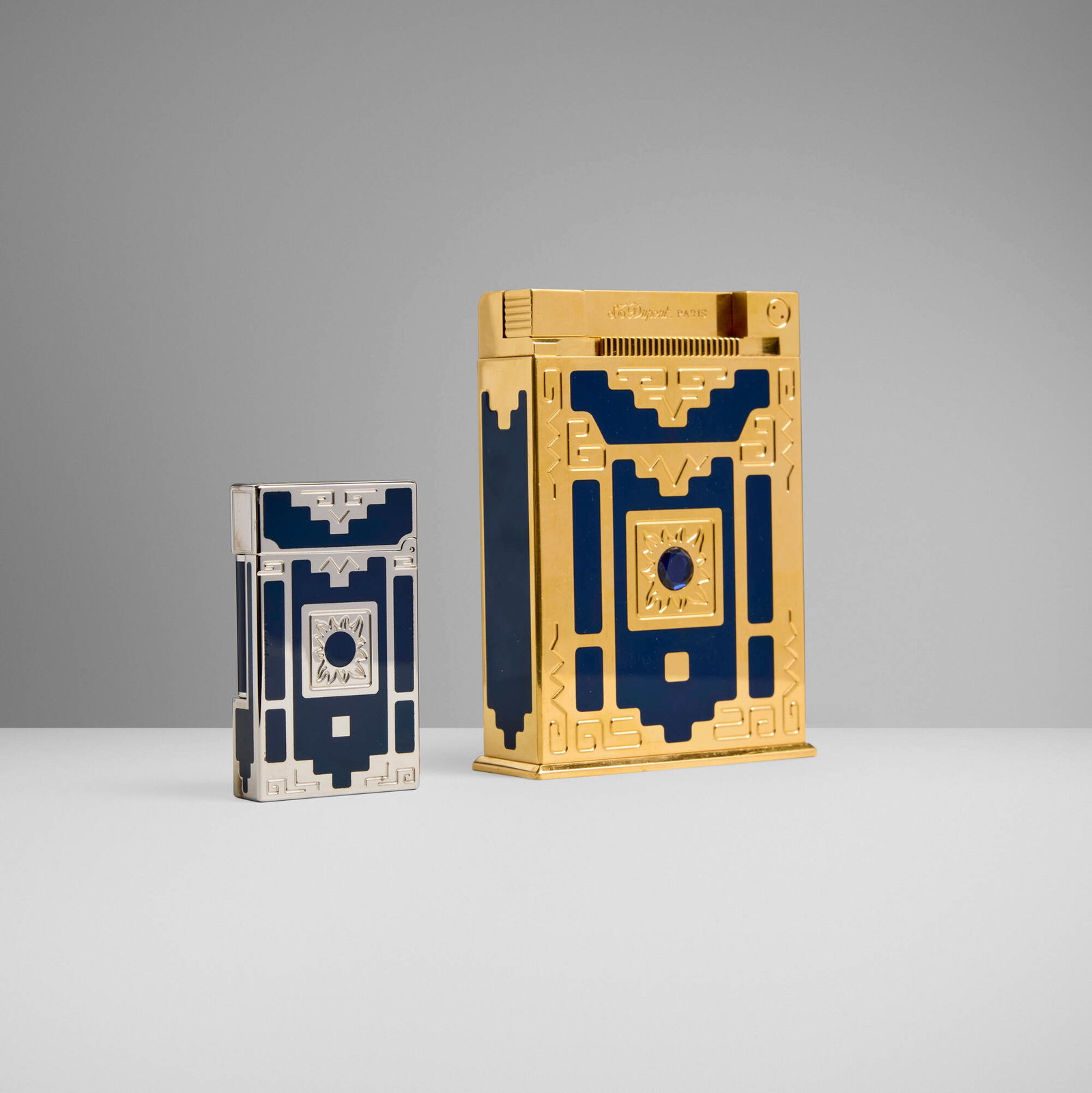 S.T. Dupont, Nuevo Mundo jeroboam table lighter and pocket lighter: S.T. Dupont Nuevo Mundo jeroboam table lighter and pocket lighter France, 1998 gold-plated metal, lacquer, blue spinel 4 h x 2.75 w x 1 d in (10 x 7 x 3 cm) 2.5 h x 1.5 w x 0.25 d in (6 x 4 x 1 cm)