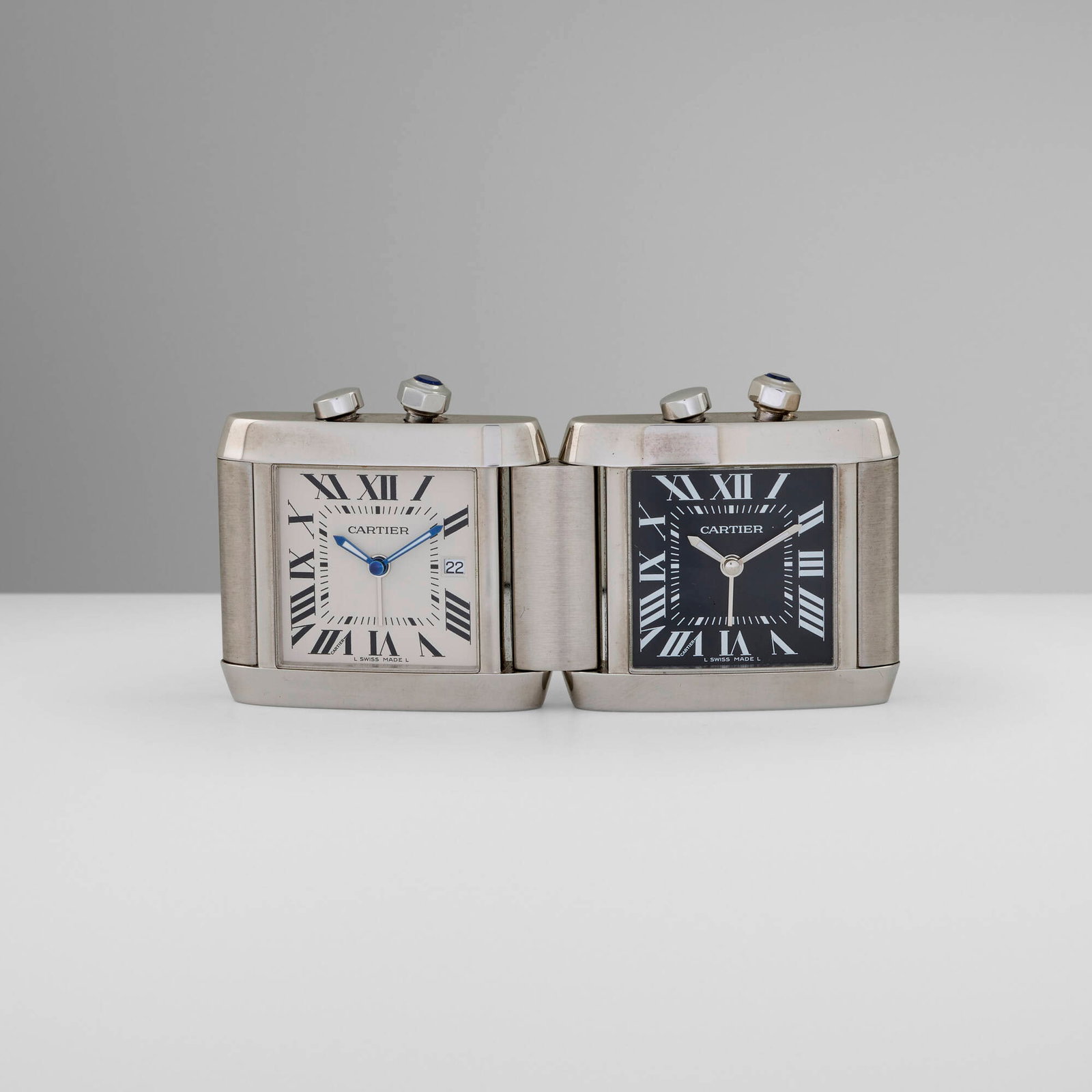 Cartier, Tank Francaise Dual Time Zone desk alarm clock: Cartier Tank Francaise Dual Time Zone desk alarm clock France / Switzerland, c. 2000 stainless steel, synthetic blue spinel 3.25 h x 1.5 w x 0.25 d in (8 x 4 x 1 cm) Printed manufacturer's mark