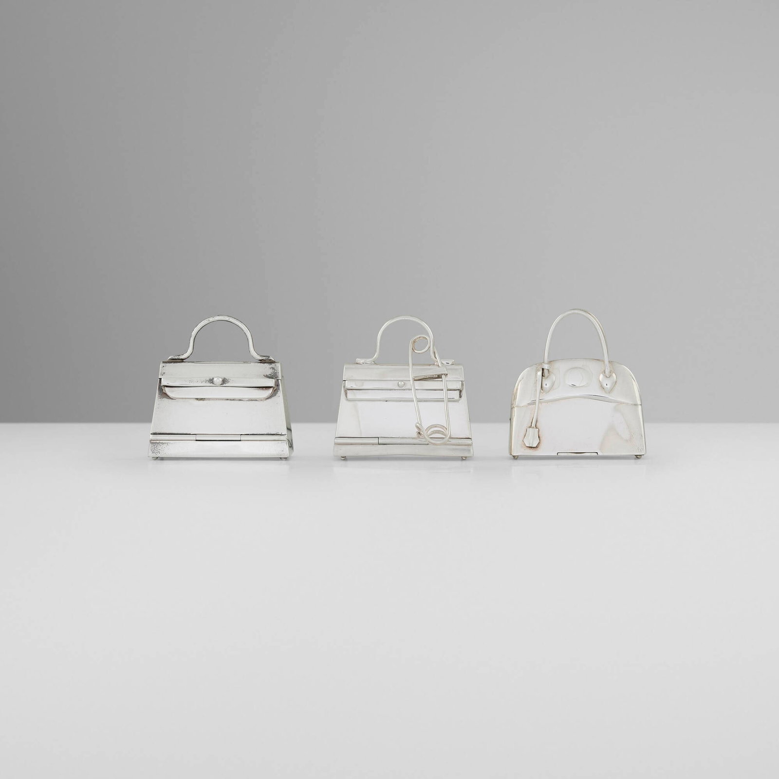 Hermes, Collection of three purse-form pill boxes (1 of 3)