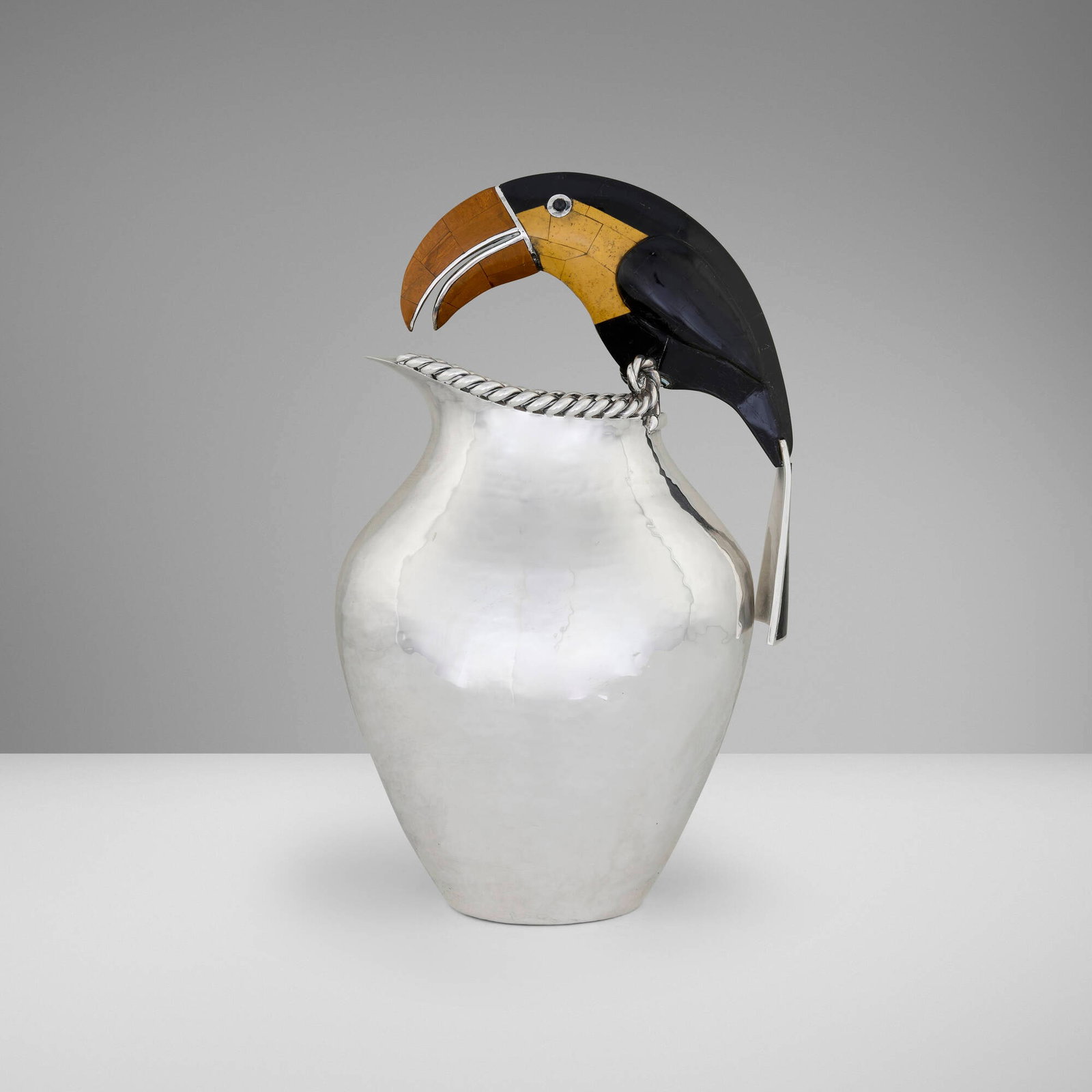 Emilia Castillo, Toucan pitcher: Emilia Castillo Toucan pitcher Mexico, c. 2000 silver-plated metal, hardstone inlay 14.25 h x 8.5 w x 5 d in (36 x 22 x 13 cm) Impressed signature to underside 'Emilia Castillo Mexico Plateado