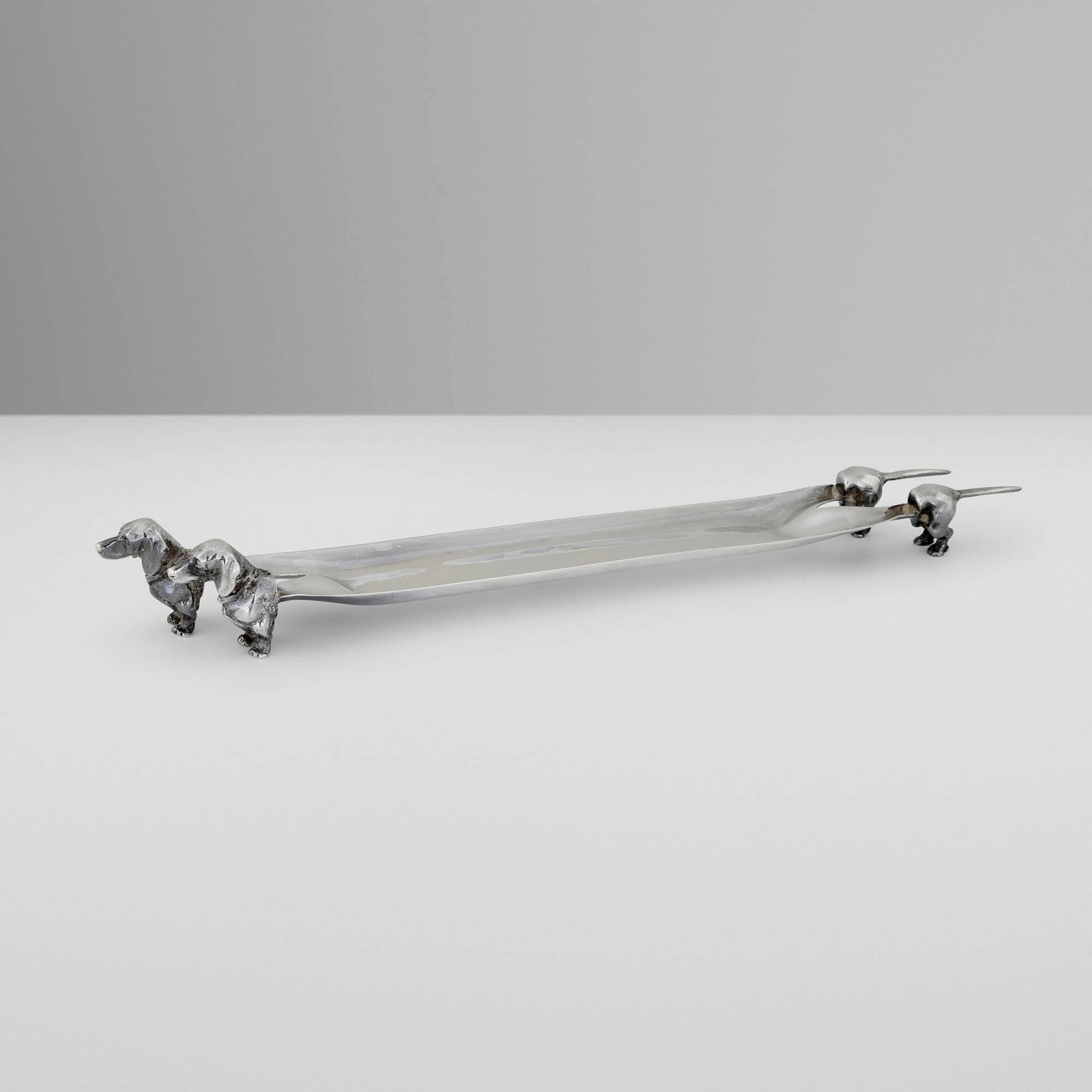 Rossi & Arcandi, Double-Dachshund pen tray: Rossi & Arcandi Double-Dachshund pen tray Vicenza, Italy, c. 1965-70 .800 silver 1.5 h x 12 w x 1.5 d in (4 x 30 x 4 cm) Impressed maker's mark to interior '266 VI 800'. 4.61 ozt. This