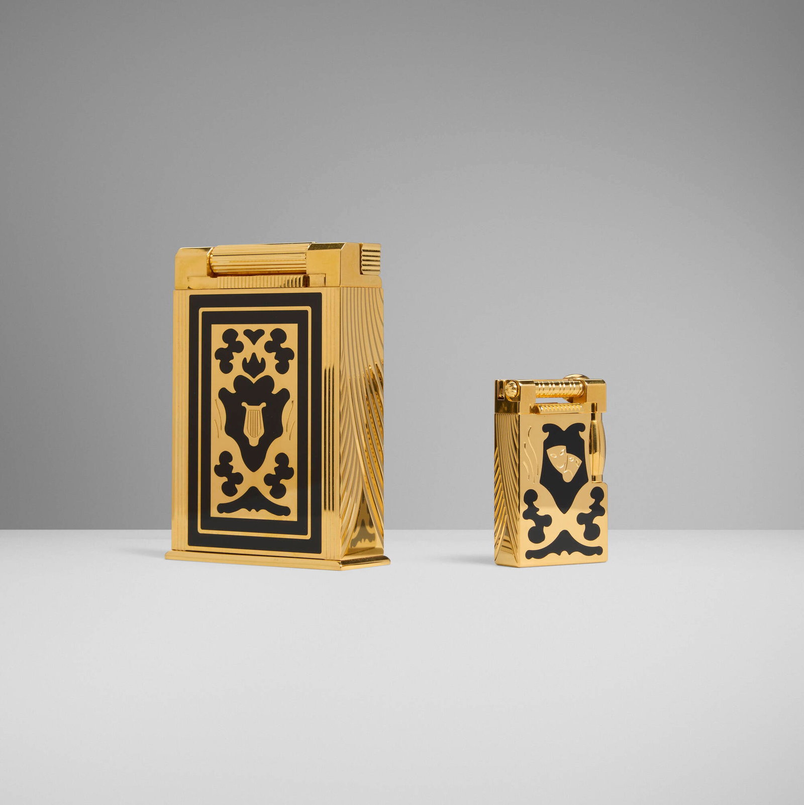 S.T. Dupont, Teatro jeroboam table lighter and pocket lighter: S.T. Dupont Teatro jeroboam table lighter and pocket lighter France, 1997 lacquer, gold-plated metal 4 h x 2.75 w x 1 d in (10 x 7 x 3 cm) 2.25 h x 1.25 w x 0.5 d in (6 x 3 x 1 cm) Impressed